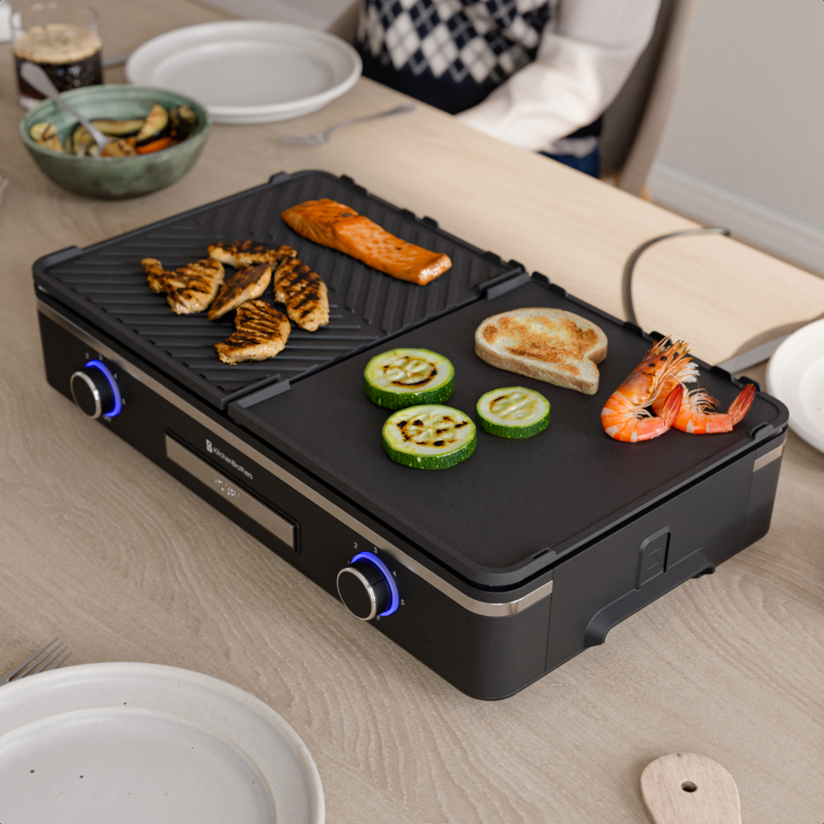 An electric grill with chicken, salmon, zucchini, bread, and shrimp.