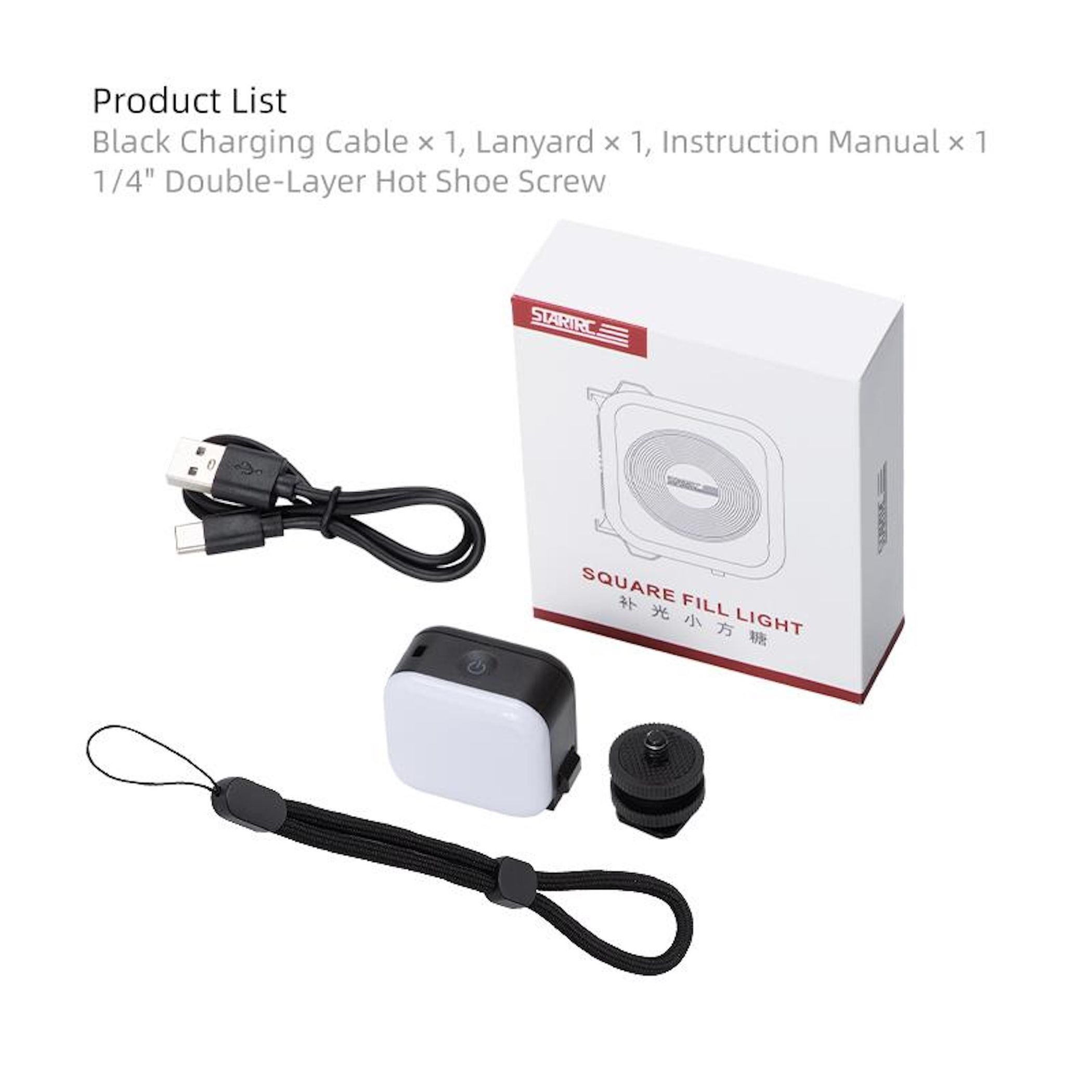 Ein schwarzes Ladekabel, ein Lanyard und ein Handbuch liegen neben einer weißen Box.