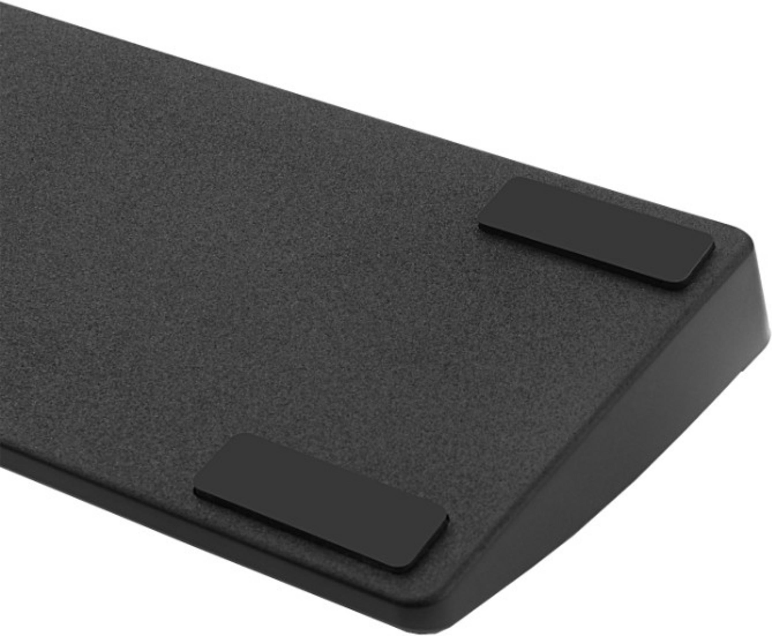Black rectangle on a gray, textured surface.