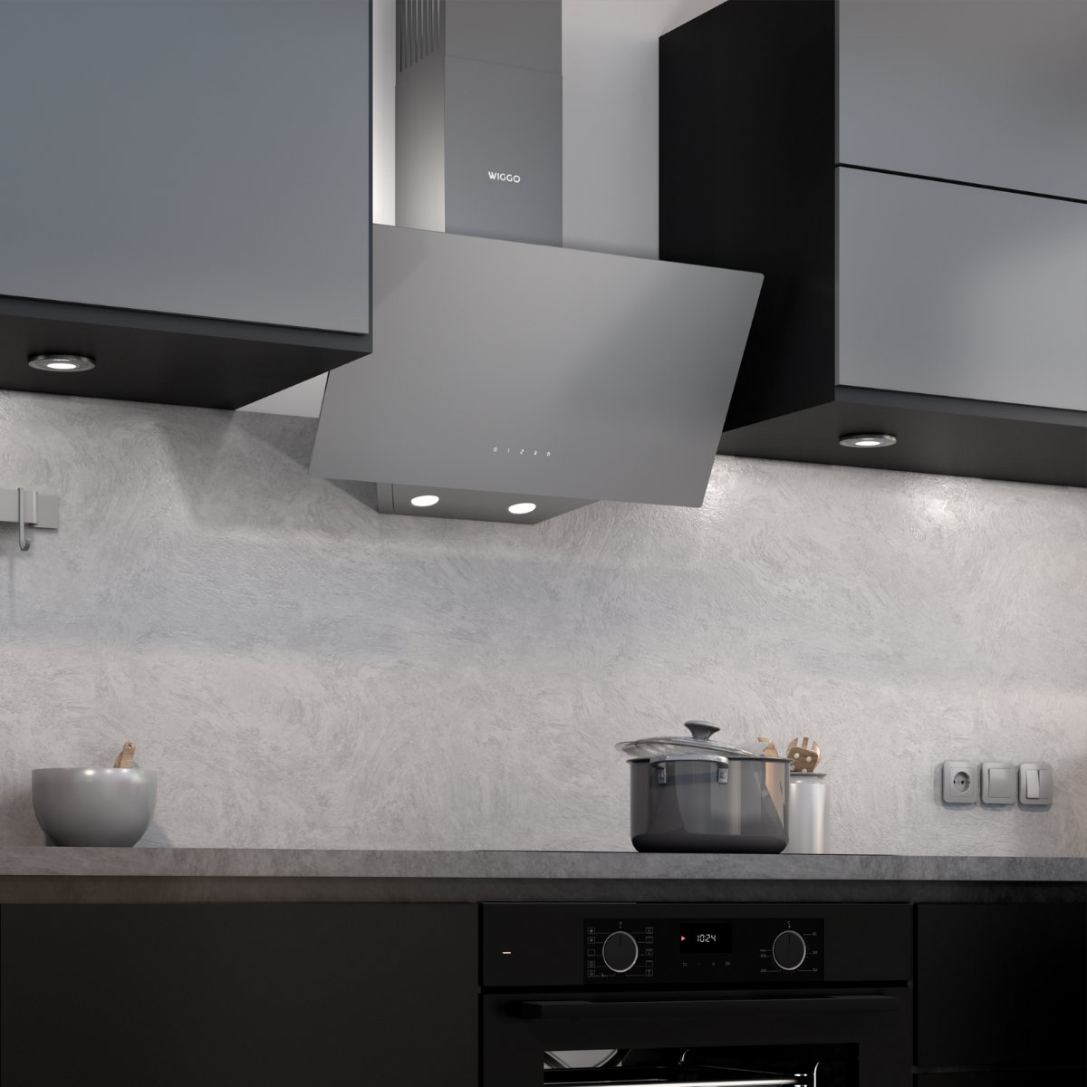 Gray range hood above a countertop with a pot and bowl.