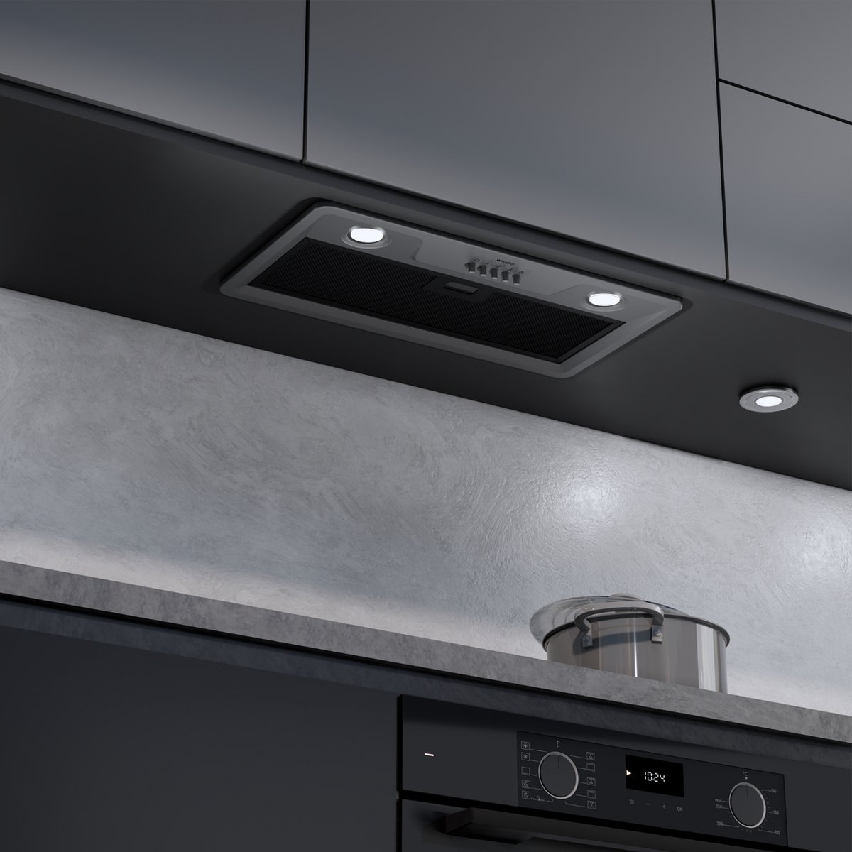 Een moderne afzuigkap boven een oven met een pan ernaast.