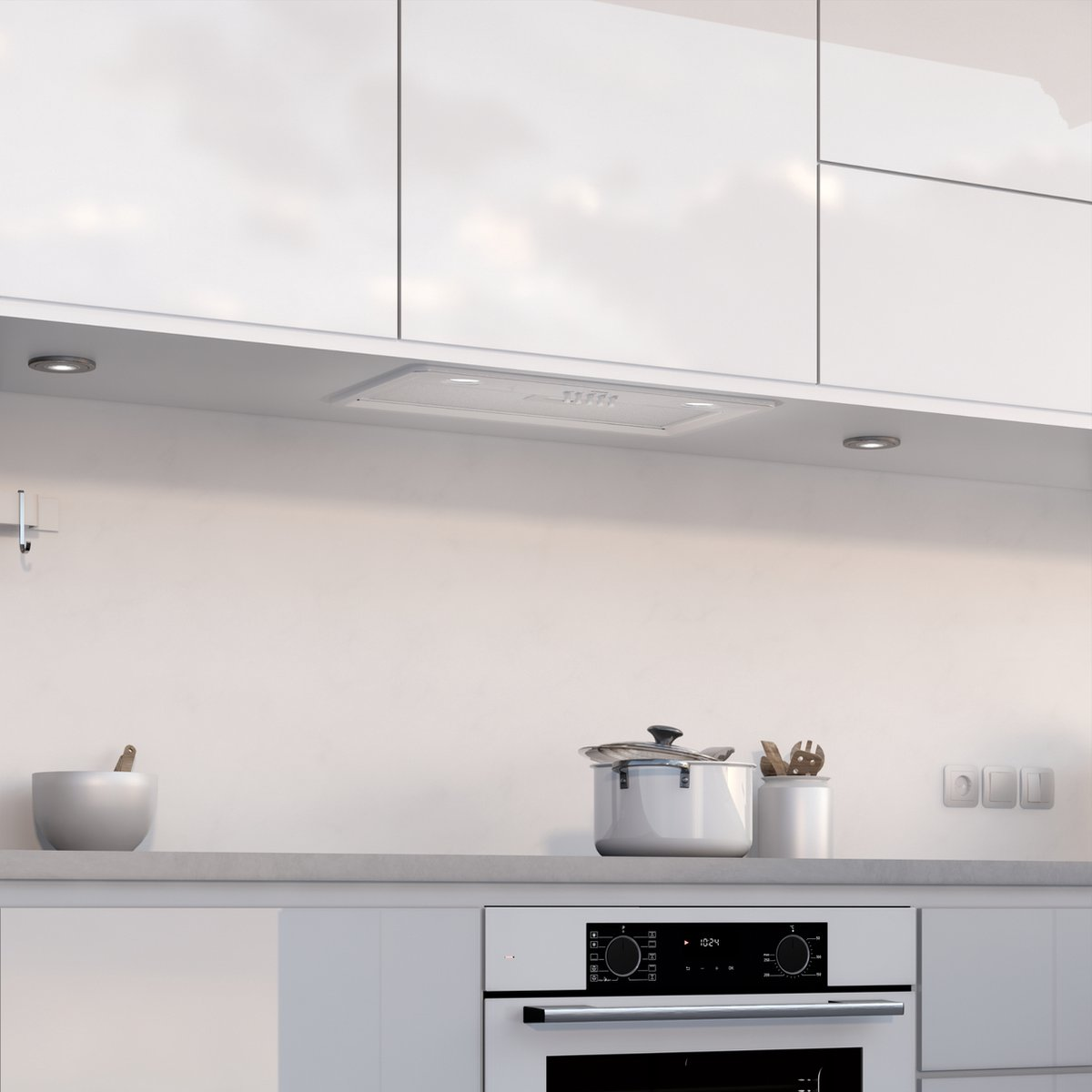 Een witte keuken met oven, afzuigkap, pan en kom.