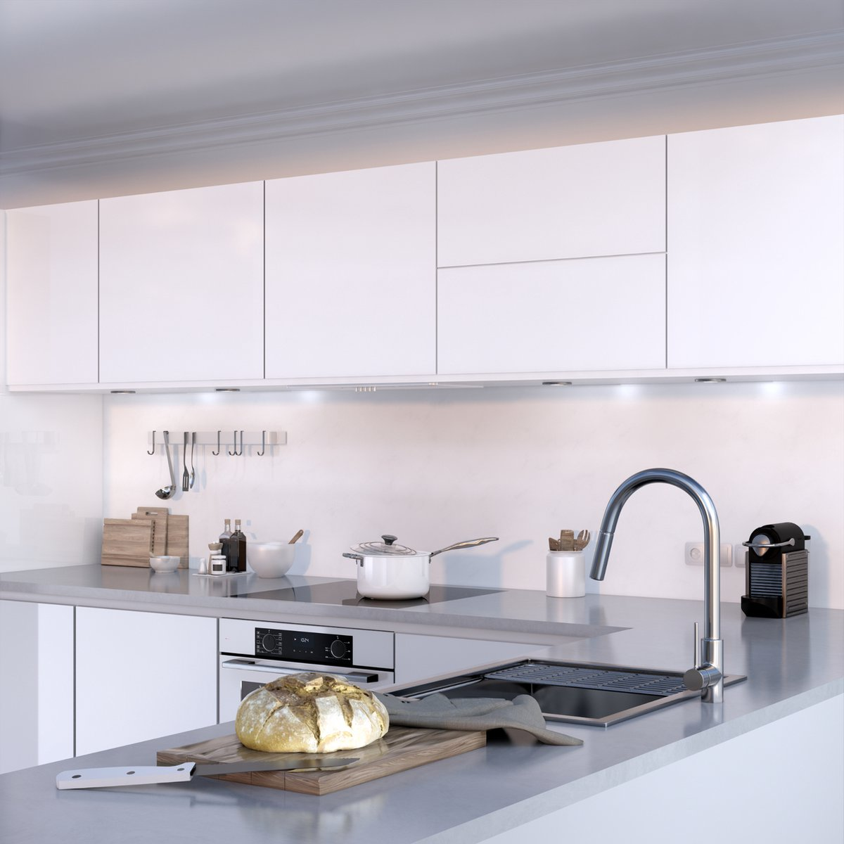 Moderne keuken met witte kasten, fornuis, gootsteen en brood.