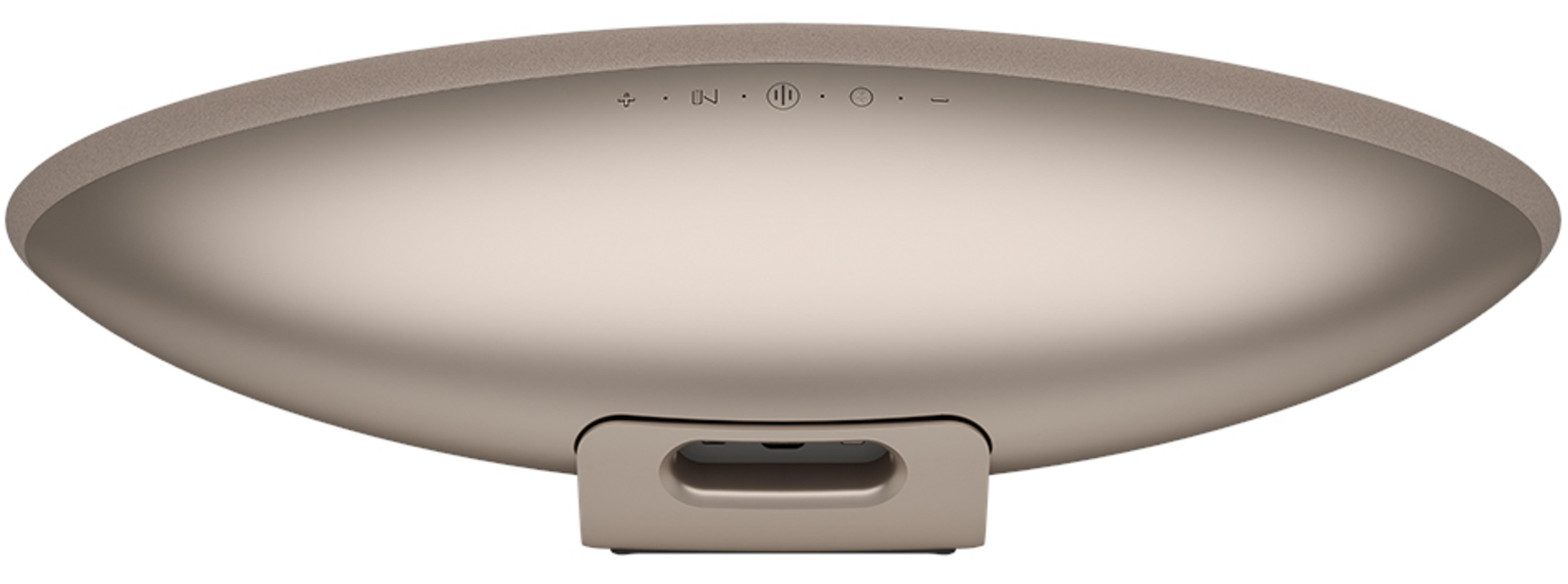 Beżowy spód głośnika z kontrolkami i uchwytem.