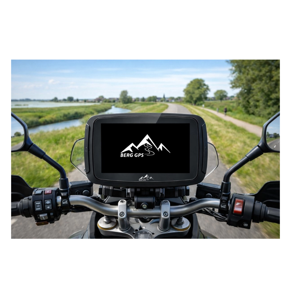Motorcycle navigation device on handlebars with mountain logo. Road and landscape in background.
