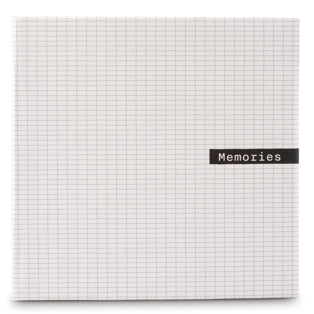 Biały notes w kratkę ze słowem "Memories" na czarnej etykiecie.