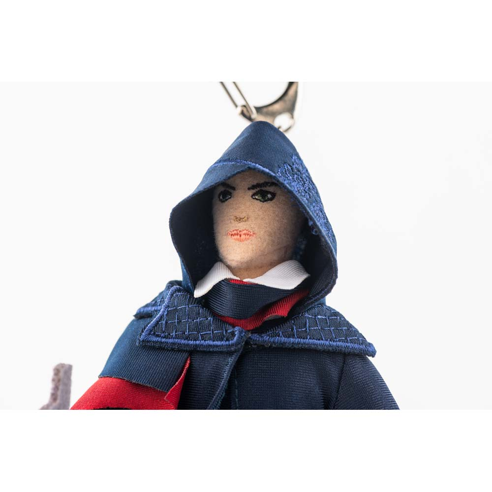 Portachiavi bambola di stoffa con cappuccio, blu con accenti rossi.