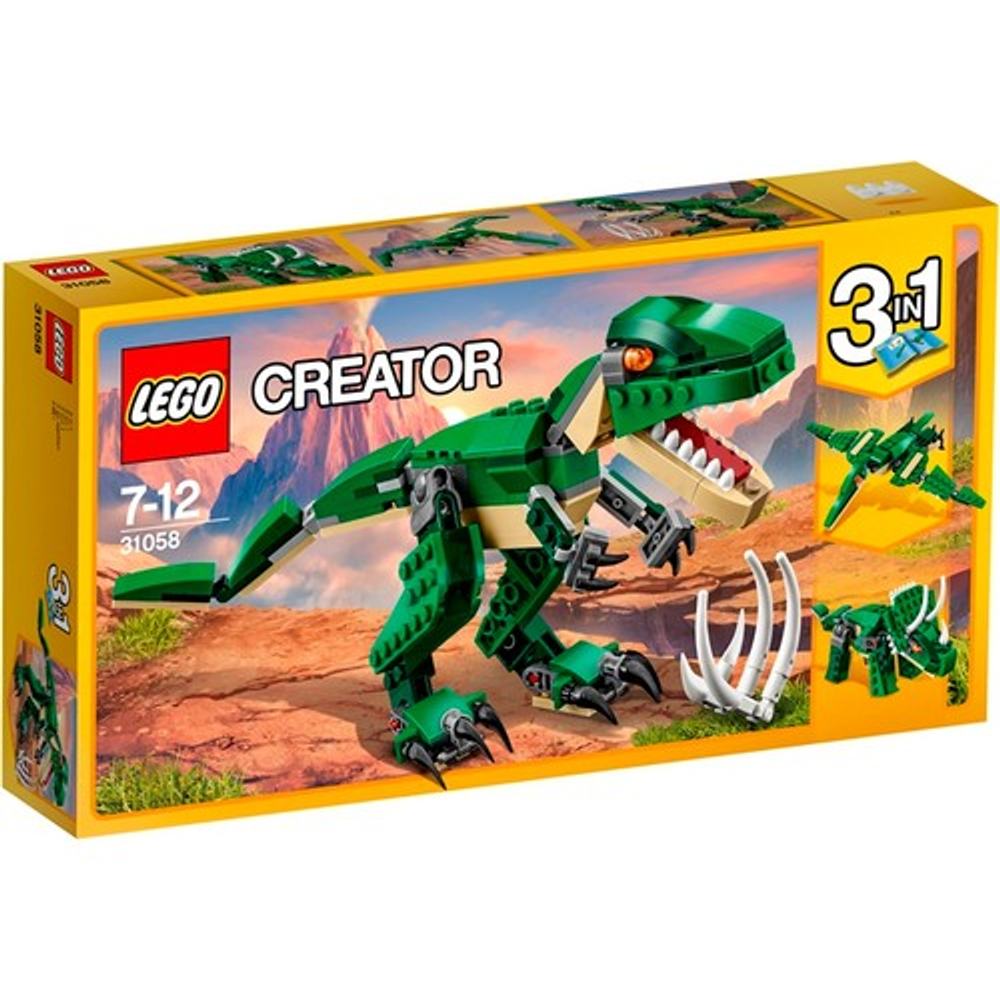 Grüner Lego Dinosaurier mit roten Augen auf einer Box mit Berglandschaft im Hintergrund.