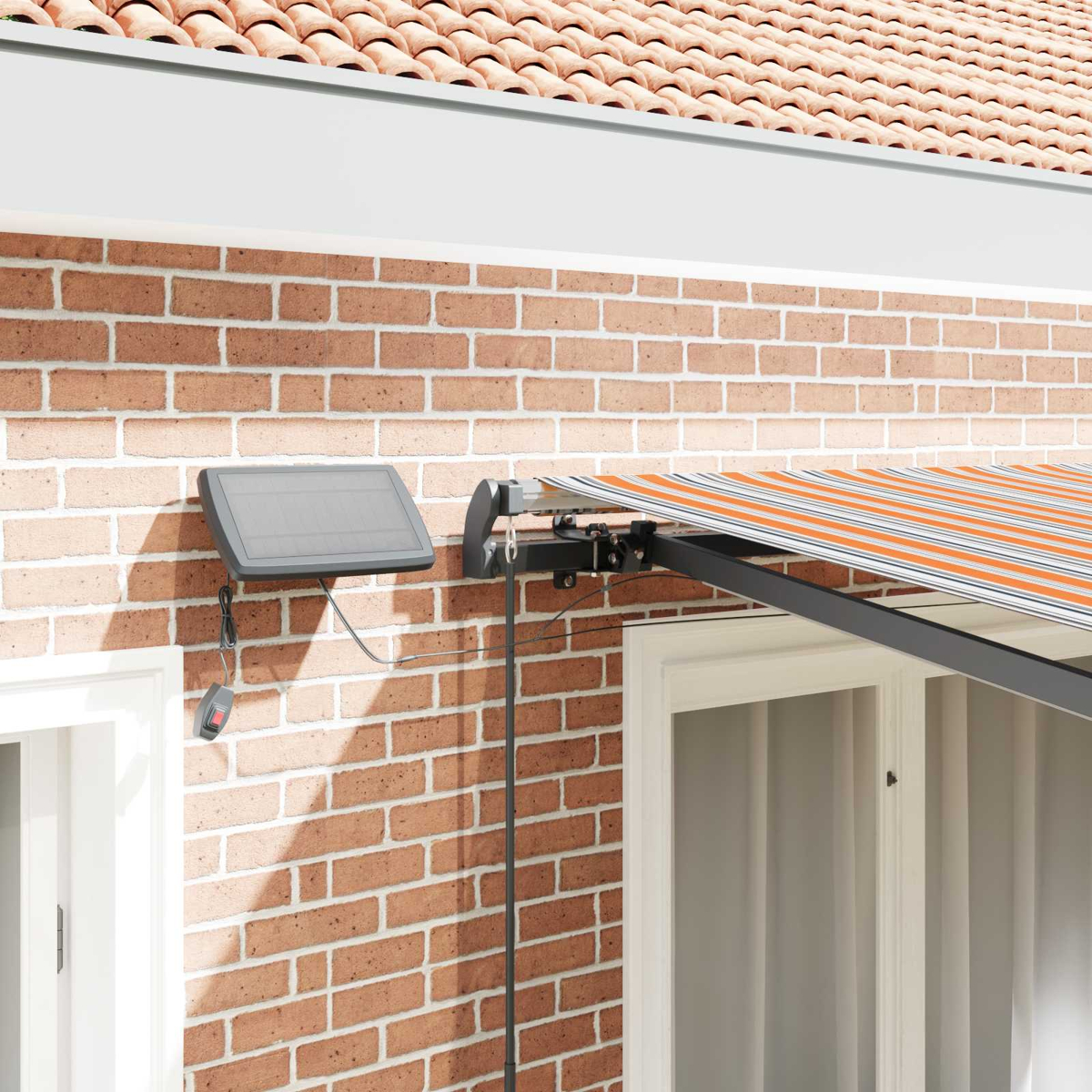 Solarpanel und Markise mit orange-weißen Streifen an einer Ziegelwand.