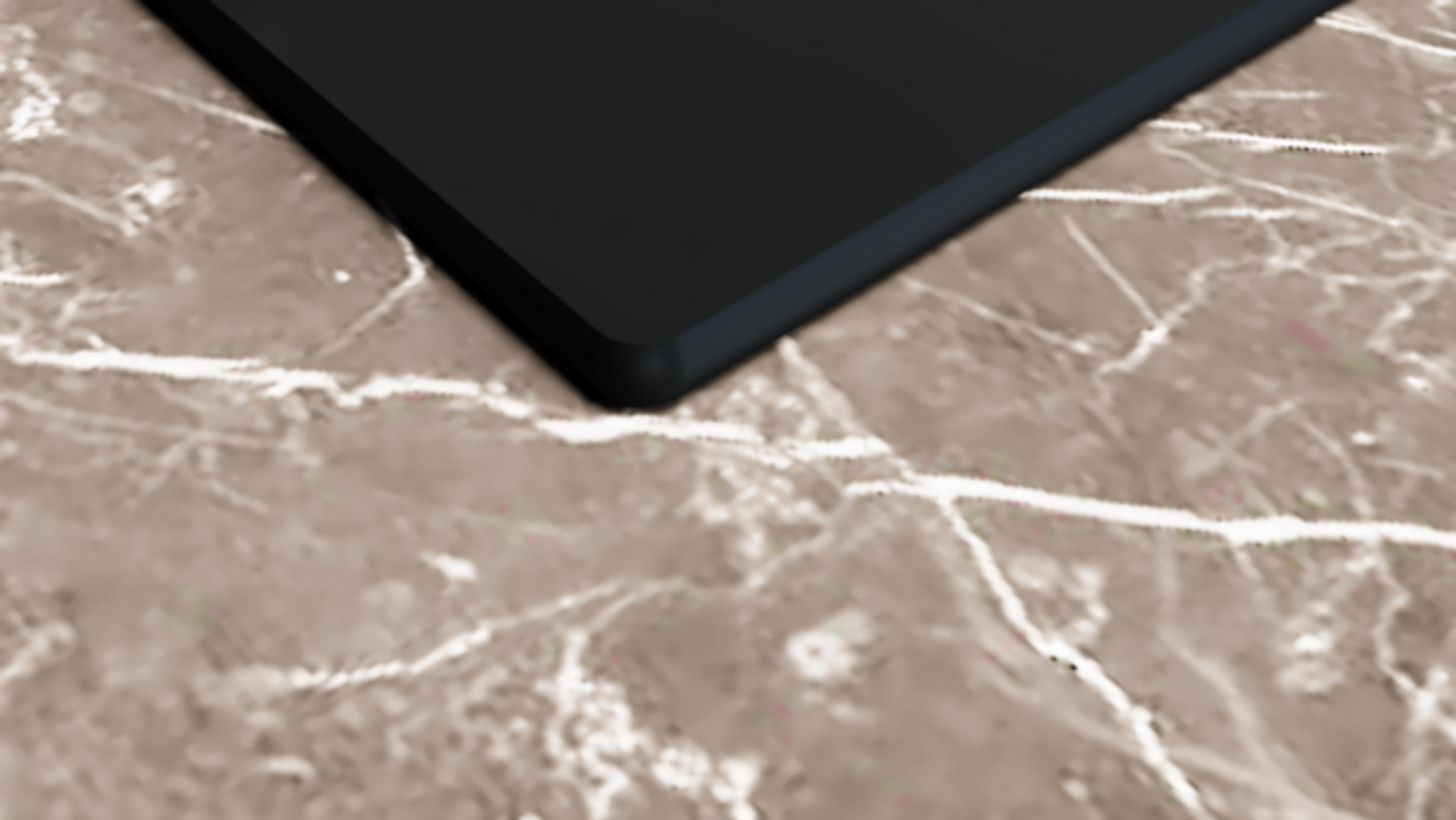 Czarny przedmiot leży na marmurowej powierzchni.