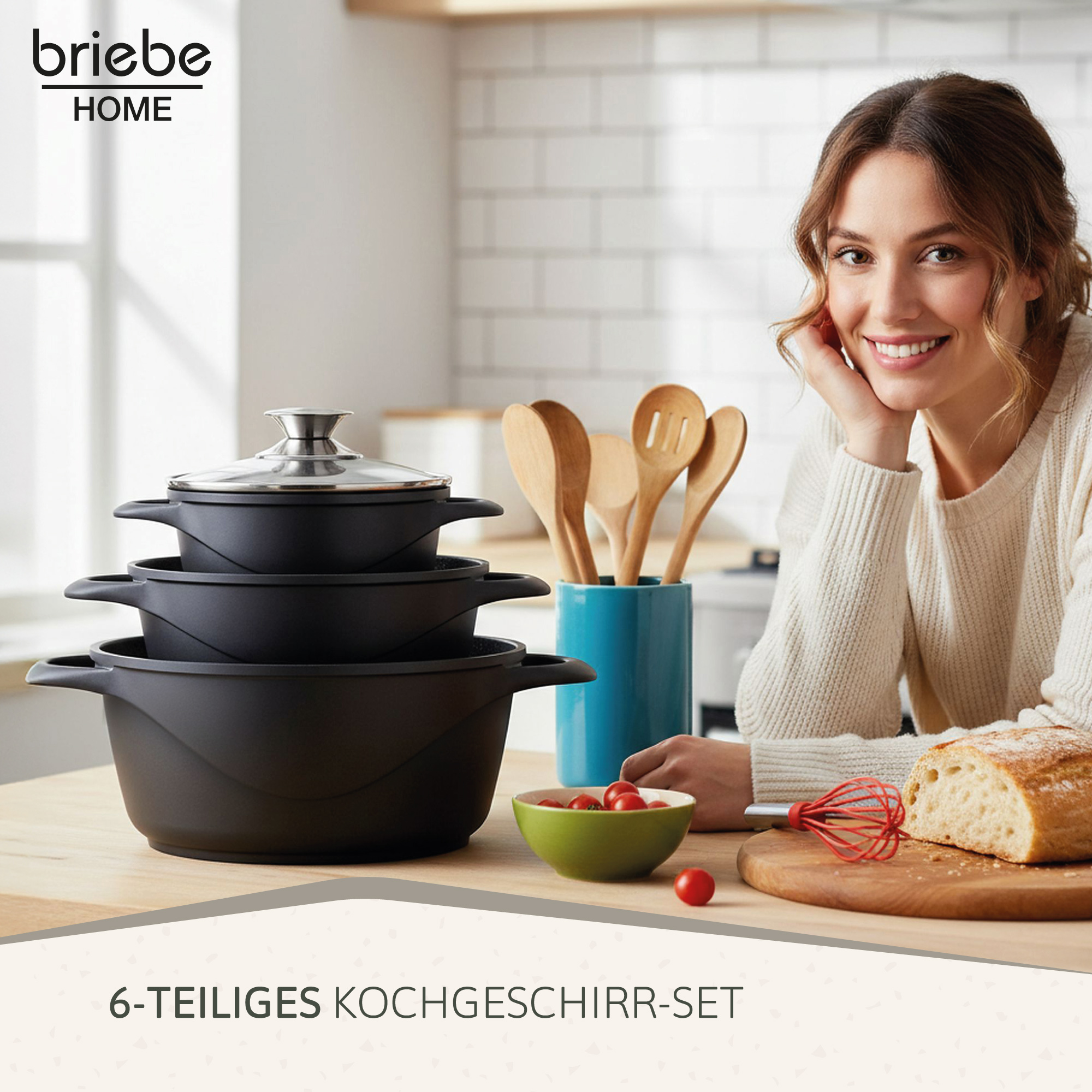 Un set de cocina con ollas, utensilios de madera, un bol de tomates cherry y pan.