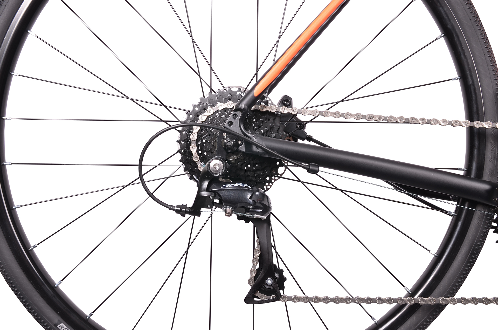 Zbliżenie tylnej przerzutki i łańcucha roweru, ze szprychami i oponą.