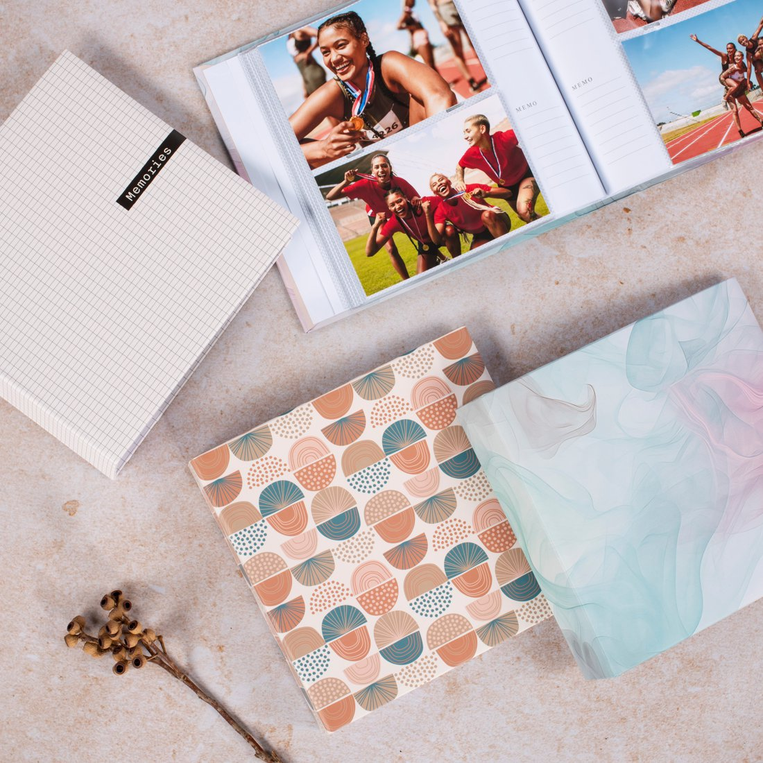 Album ze zdjęciami sportowymi i trzy książki na stole.