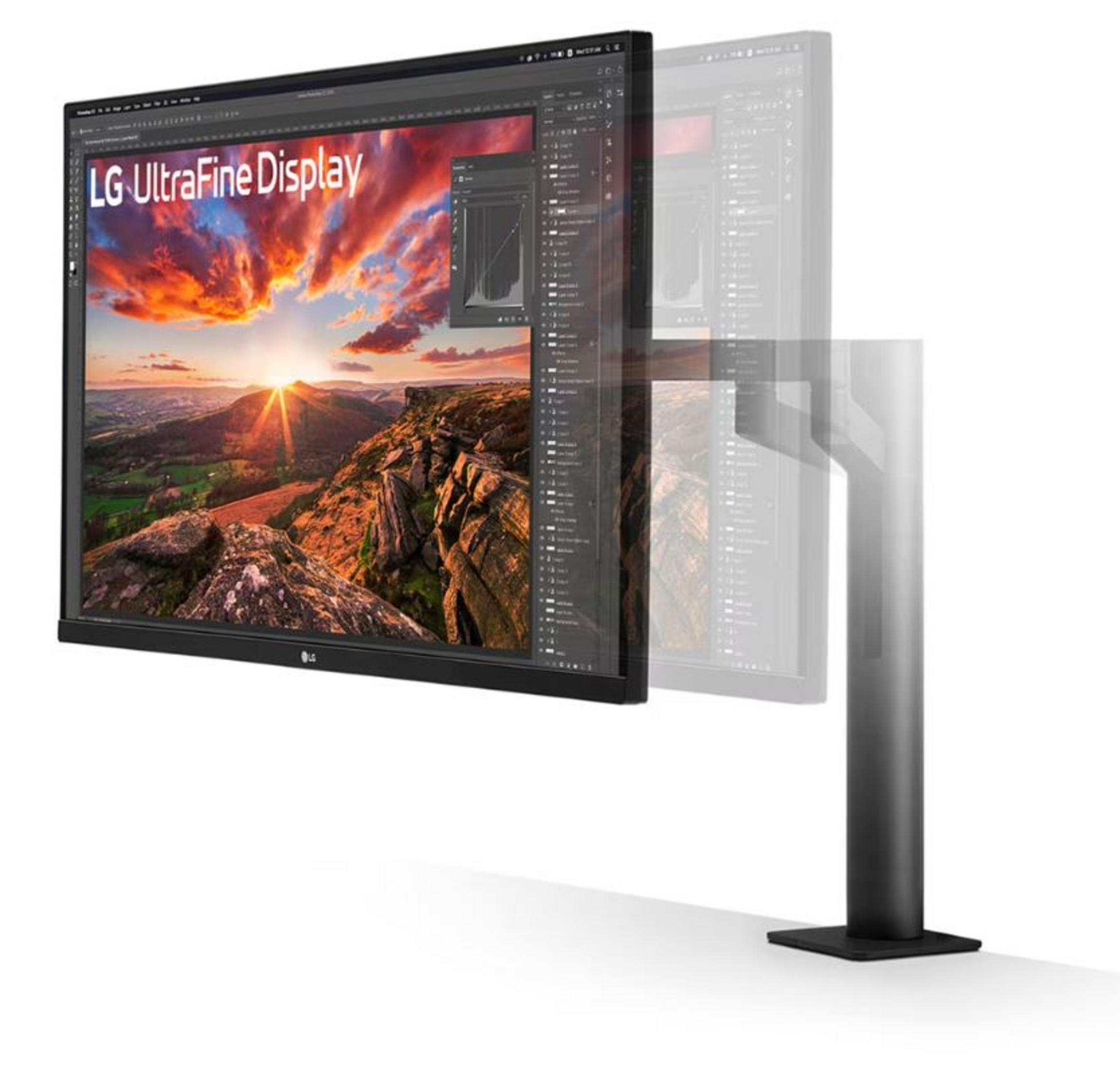 LG UltraFine Ekran, dağ gün batımı manzarasını bir stant yanında gösteriyor.