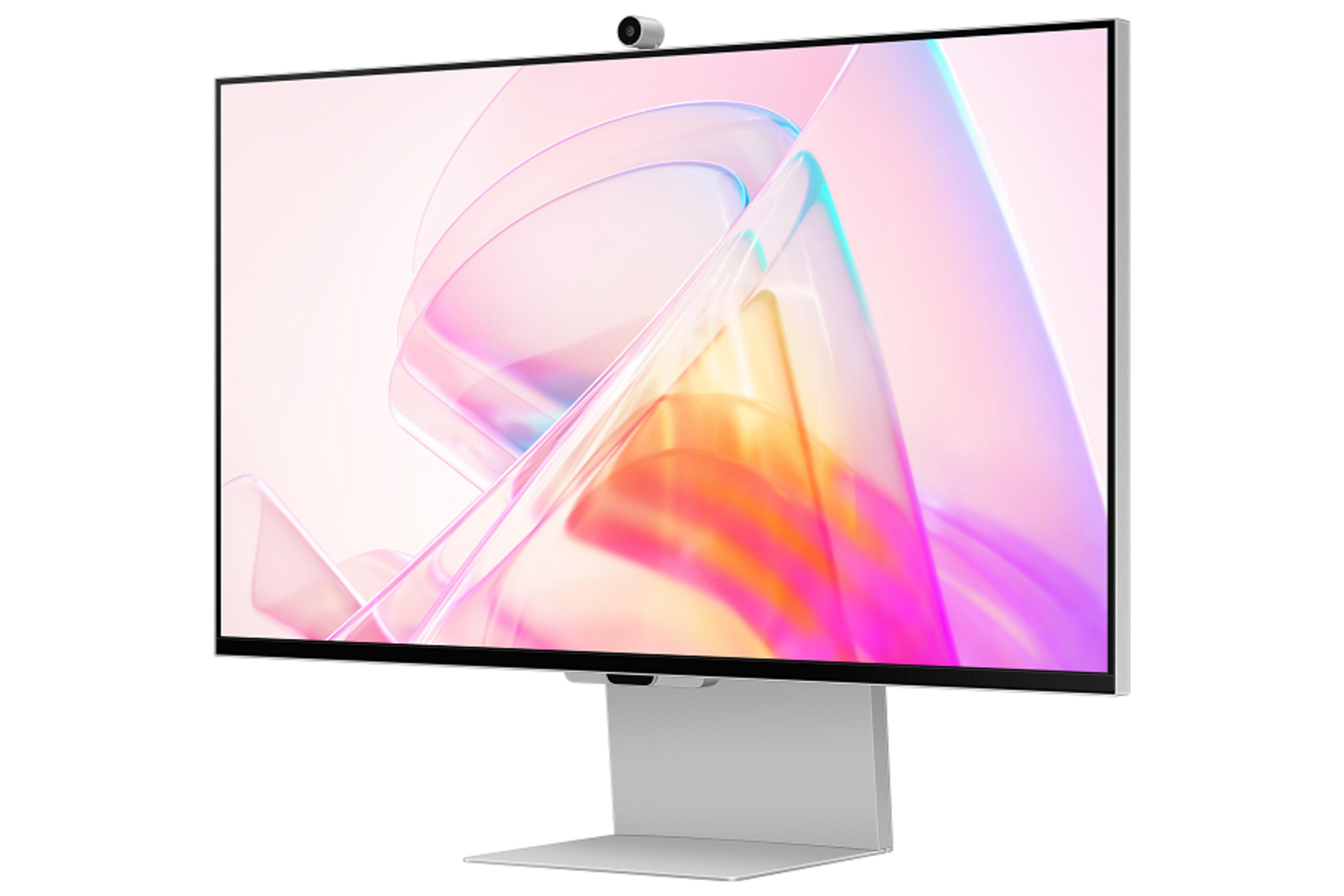 Gümüş renkli monitör, web kamerası ve pastel soyut arka plan.