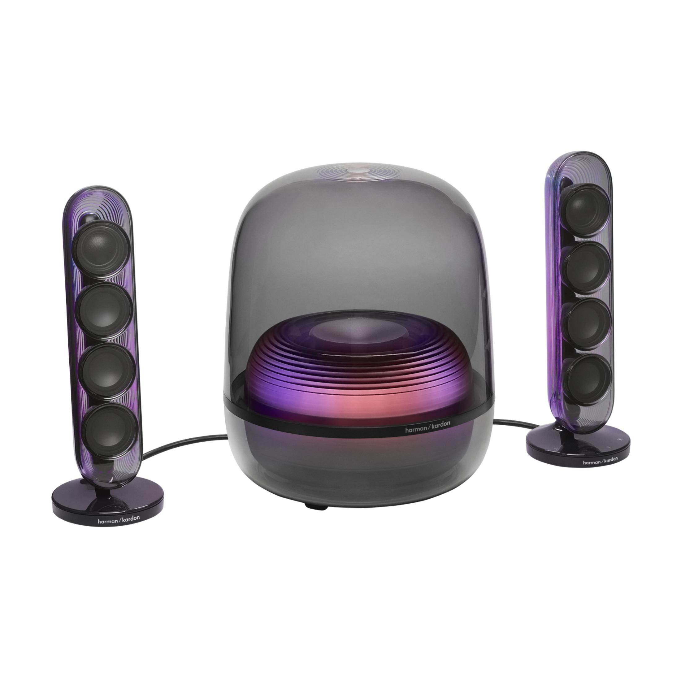 Zwei schlanke Lautsprecher mit vier Treibern und ein runder Subwoofer mit Farbwechsel.