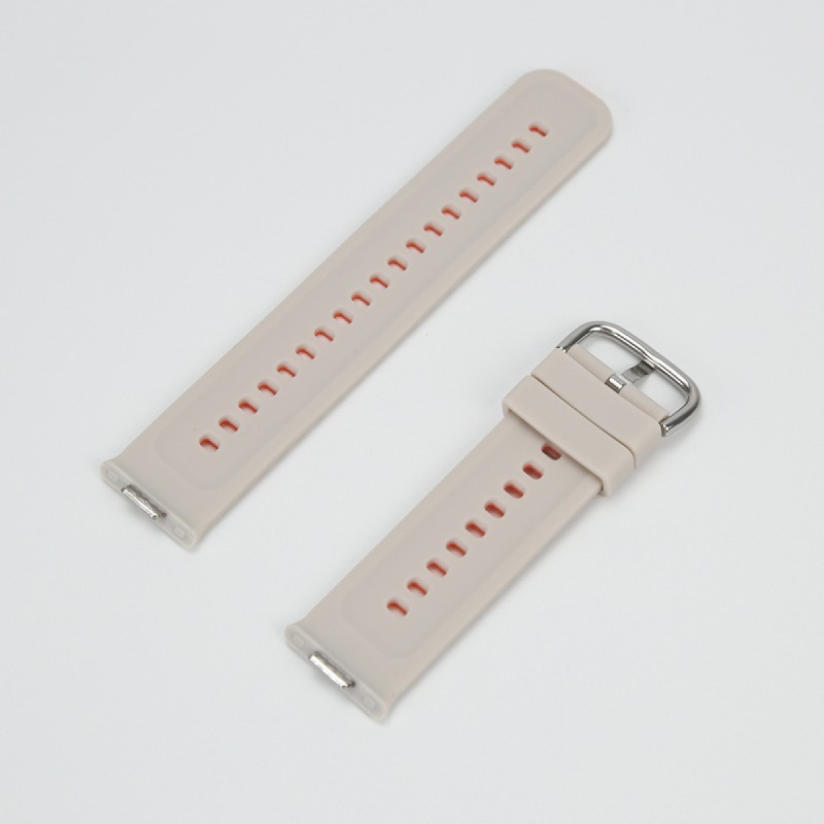 Zwei hellbeigefarbene Uhrenarmbänder mit roten Lochöffnungen und Metallschnalle.
