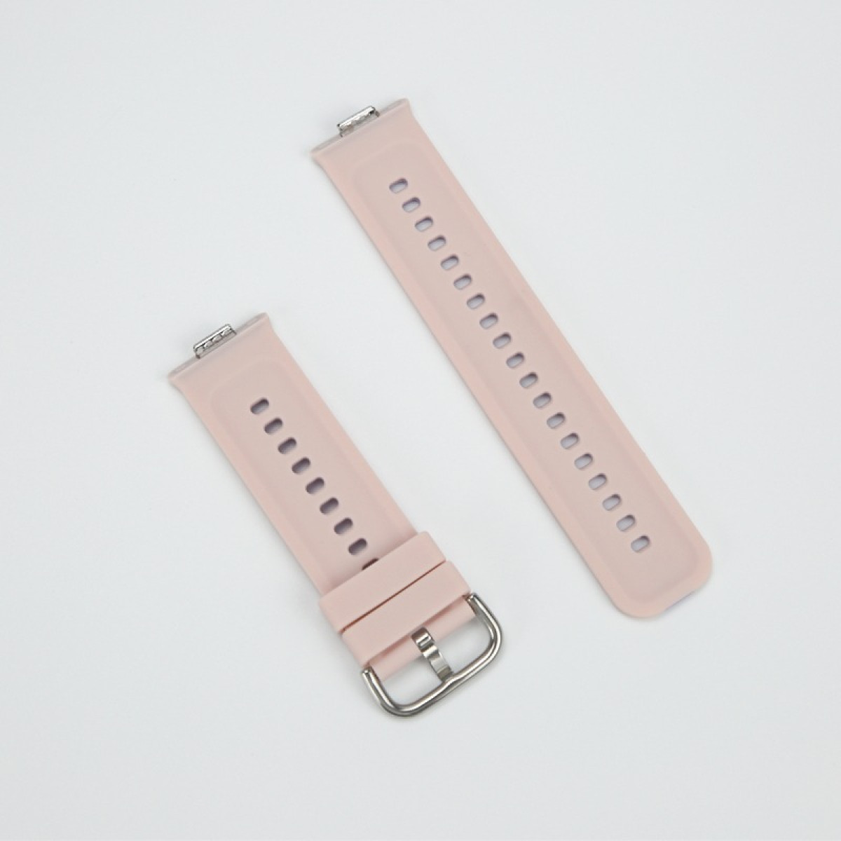 Due cinturini per orologio rosa con fibbia argentata e fori su sfondo bianco.