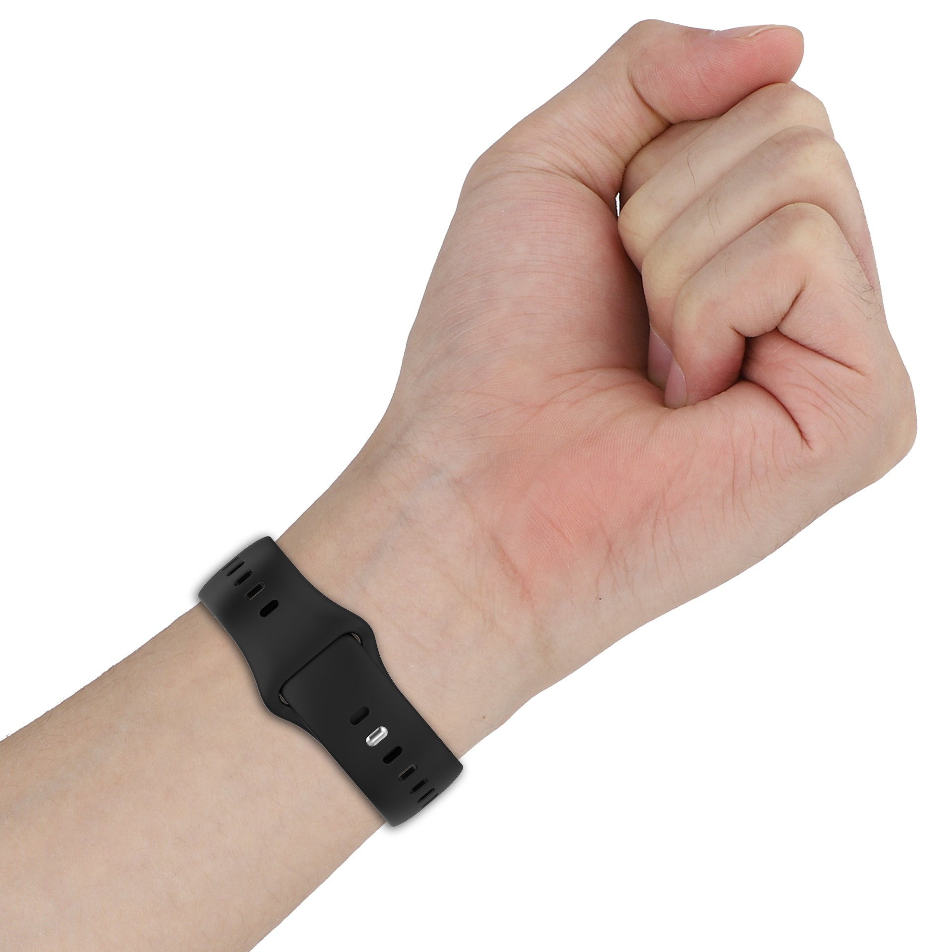 Ein schwarzes Uhrenarmband an einem menschlichen Handgelenk mit geballter Faust.
