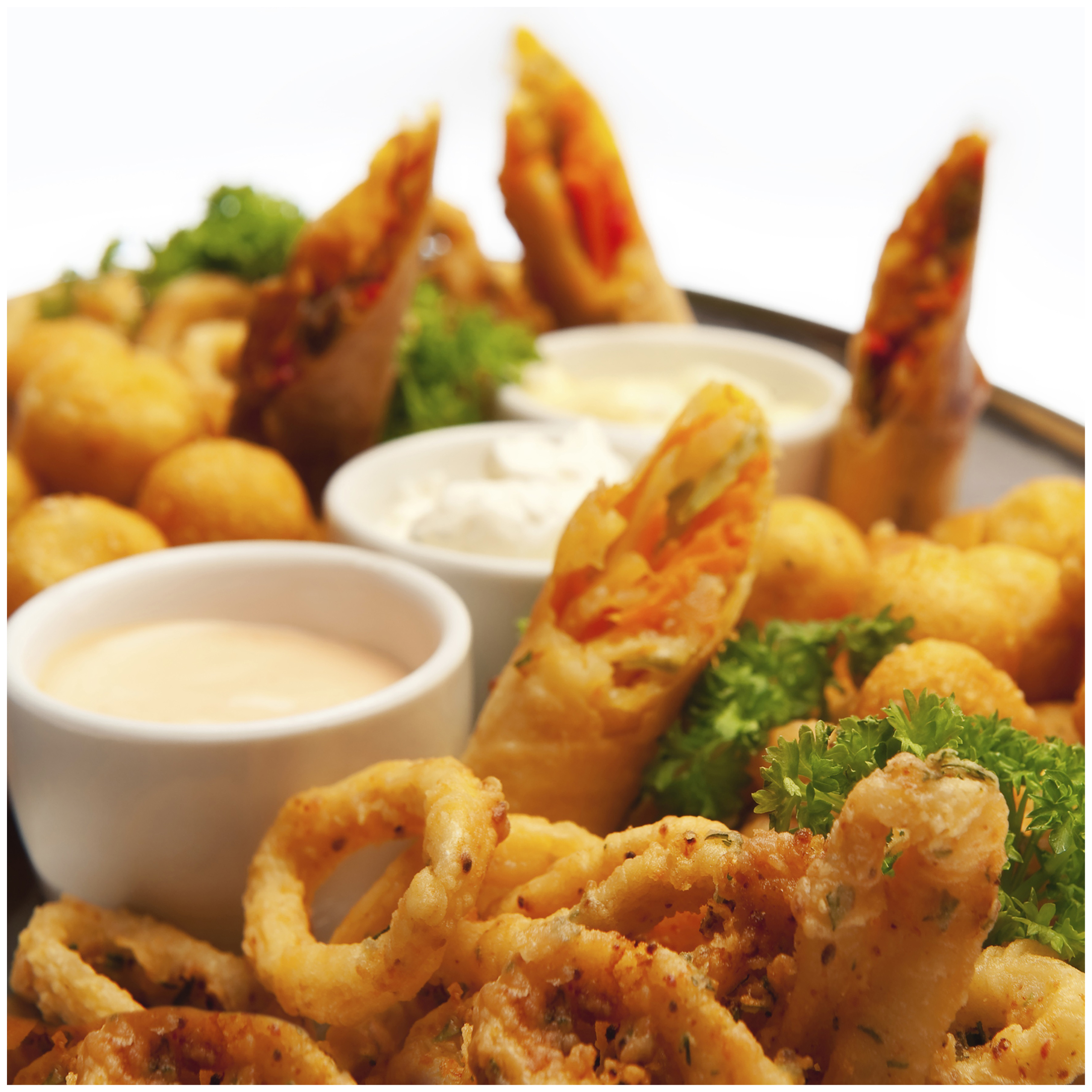 Fried calamari, spring rolls, and potato croquettes with dips.