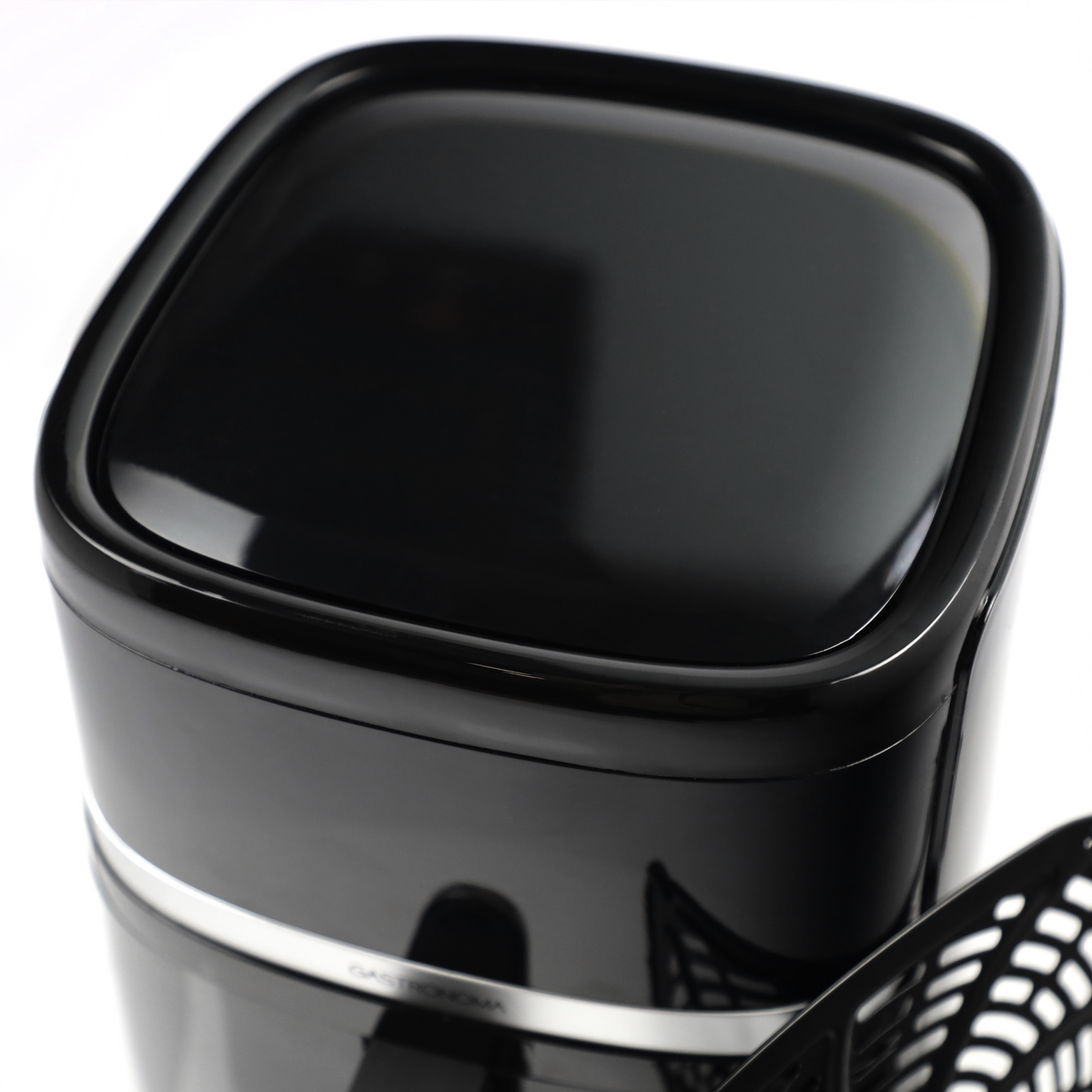 Czarny, błyszczący pojemnik z srebrnym paskiem i kratką na pierwszym planie.