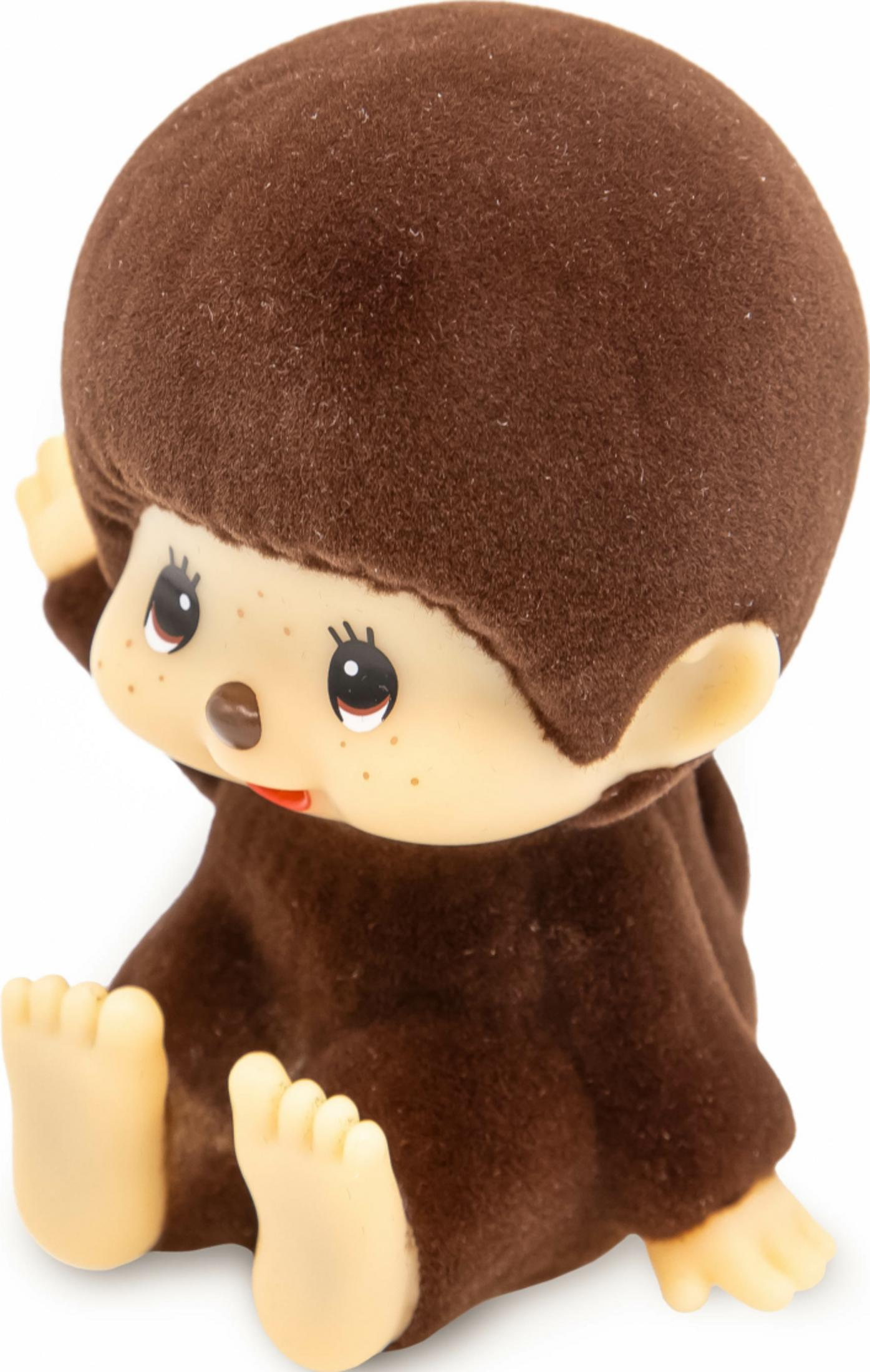 Ein brauner Monchhichi-Spielzeug mit hellbeigen Füßen und Händen.