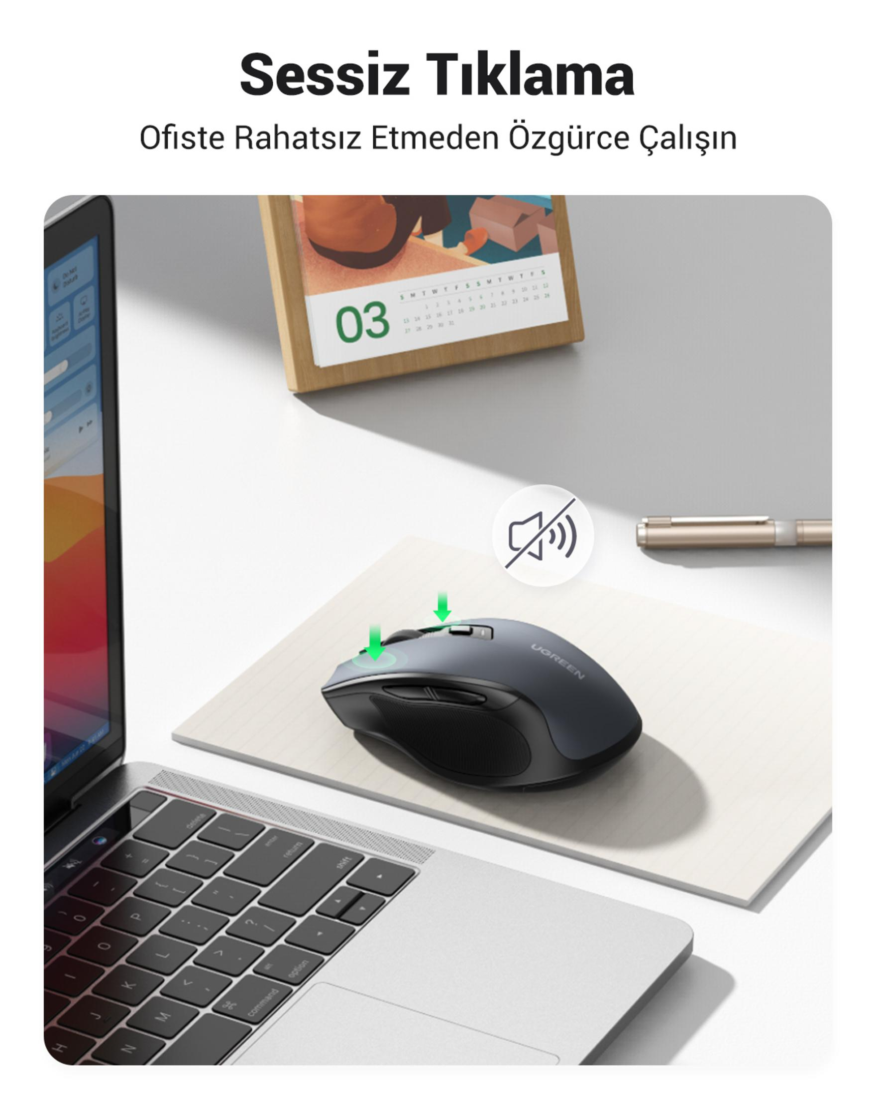 Szara bezprzewodowa mysz UGREEN na notesie obok laptopa i kalendarza.