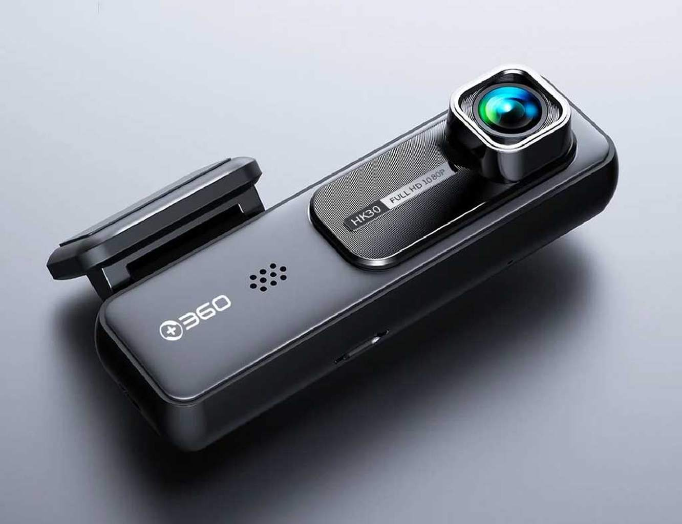 Een zwarte 360 dashcam met zilveren accenten op een grijze achtergrond.
