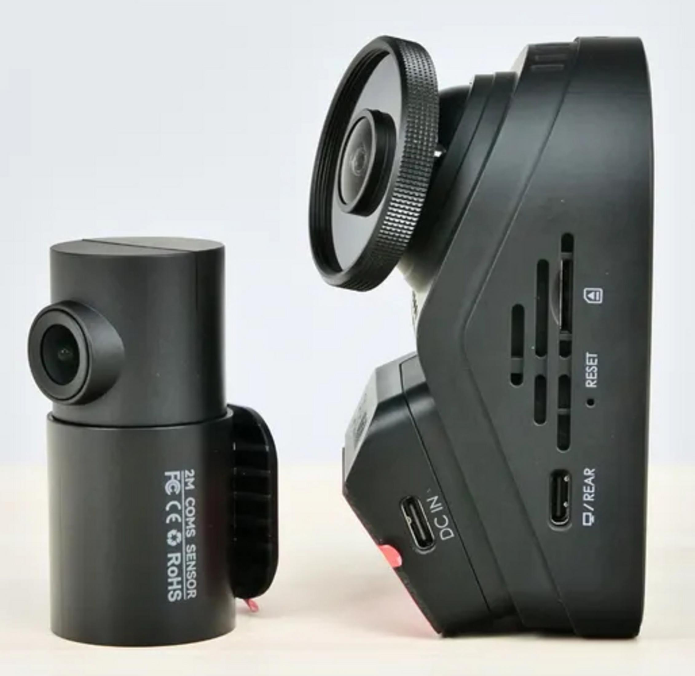 Two black dash cams, one cylindrical, the other rectangular, on a light background.
