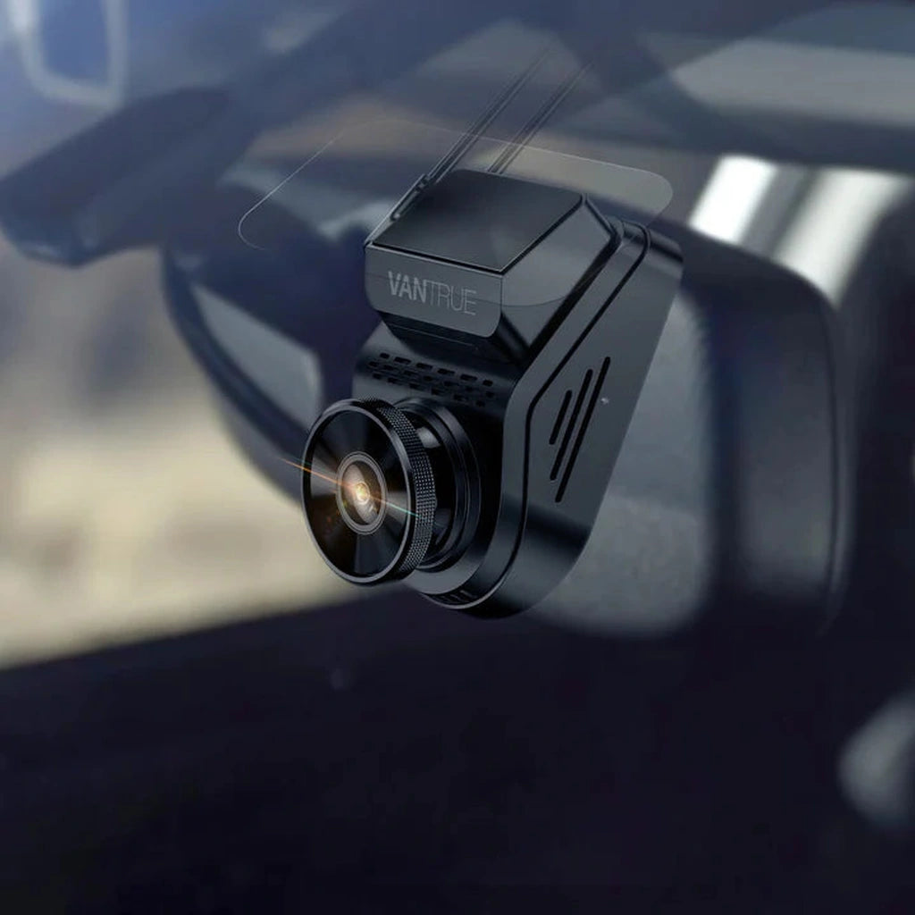 A black VANTRUE dashcam is attached to a windshield, with a rearview mirror in the background.