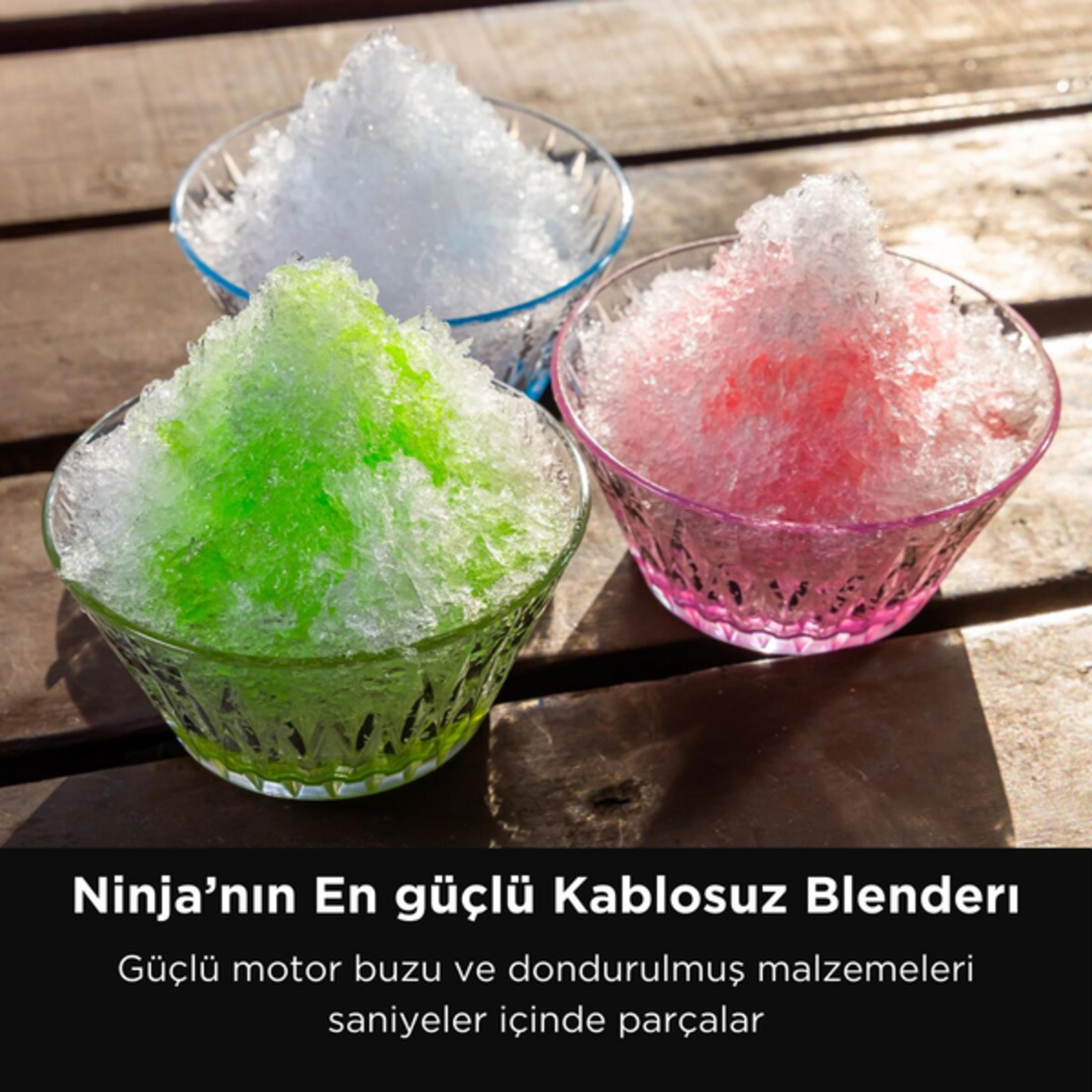 Drei Schüsseln mit zerstoßenem Eis in Grün, Weiß und Rosa auf Holztisch.