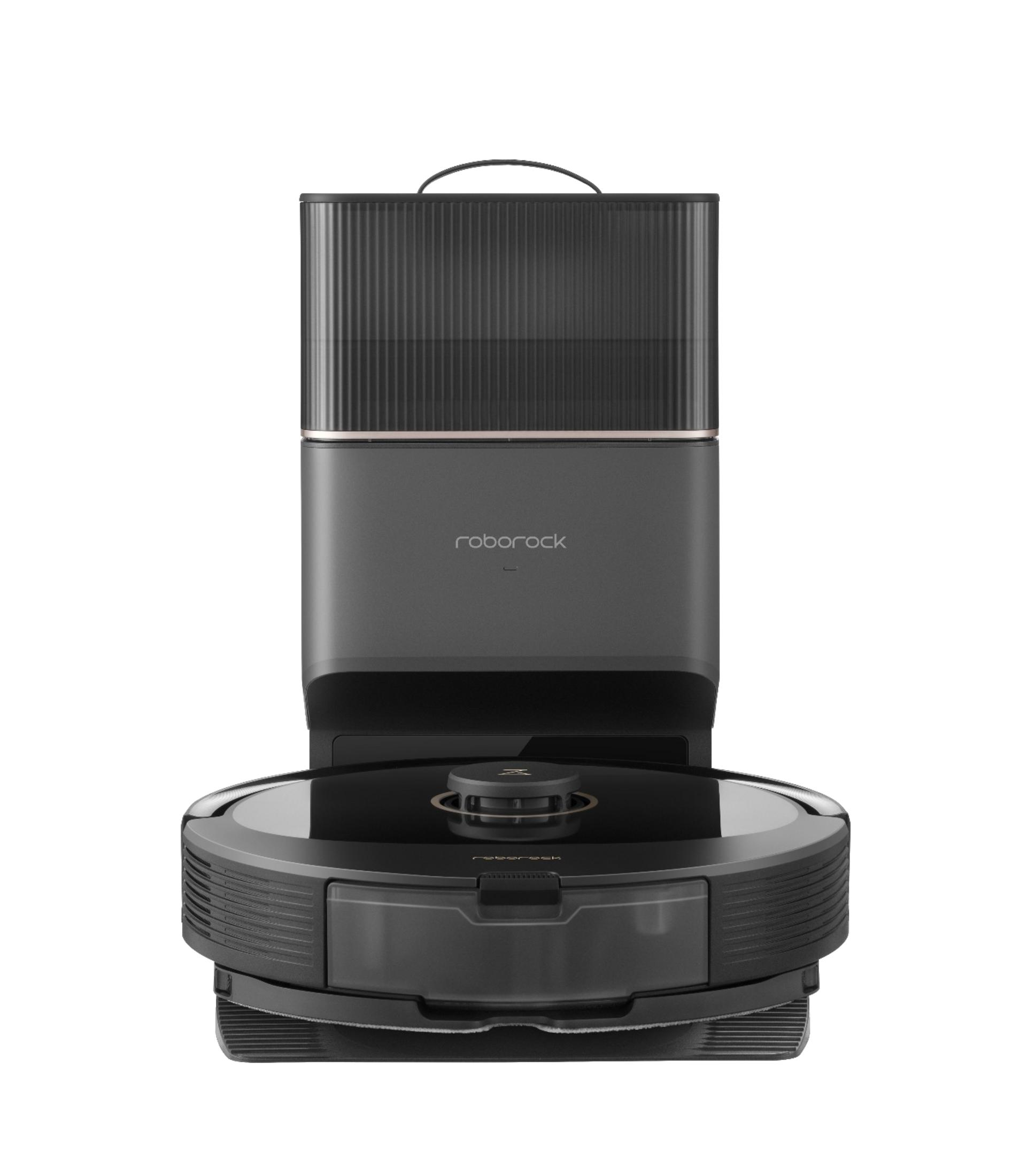 Szary robot sprzątający ze stacją dokującą. Ma pionową, prążkowaną teksturę.