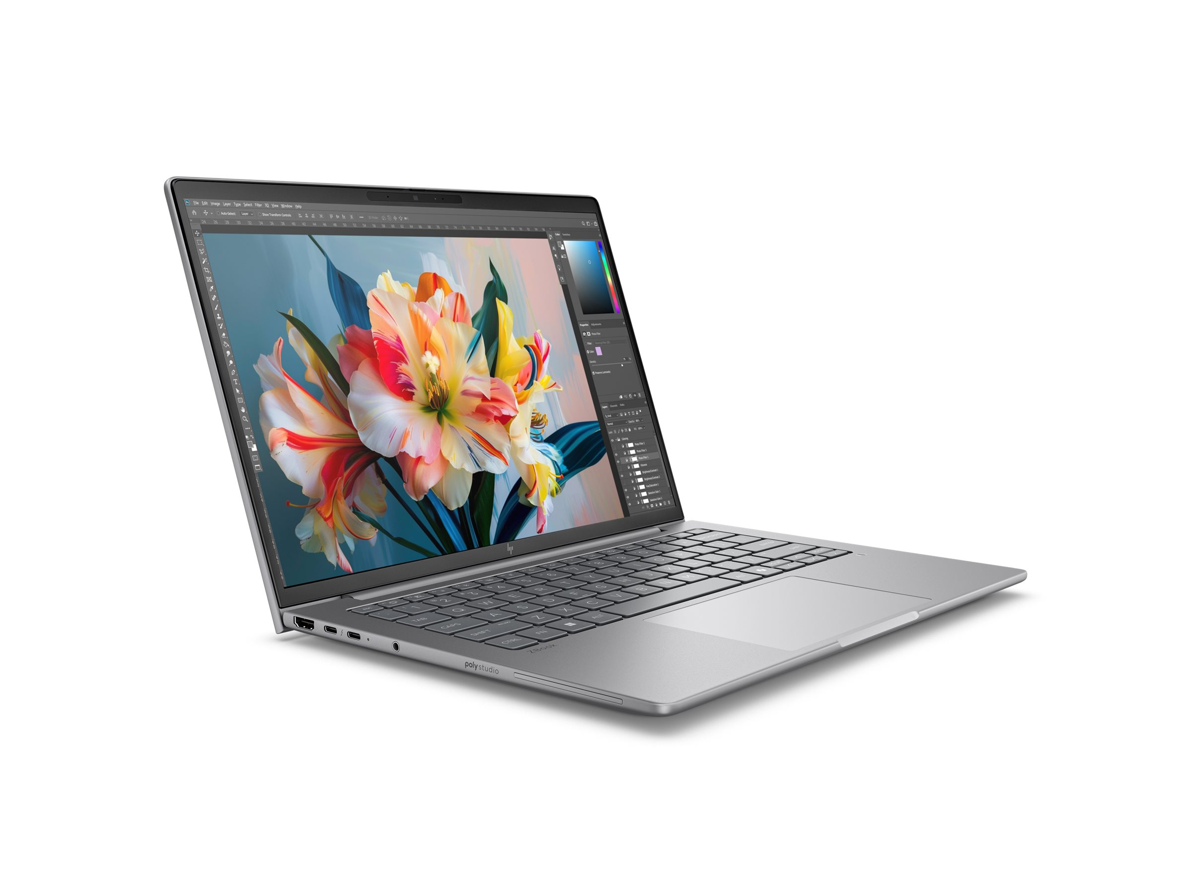 Srebrny laptop z otwartą pokrywą, wyświetlający ekran z kwiatami i klawiaturę.