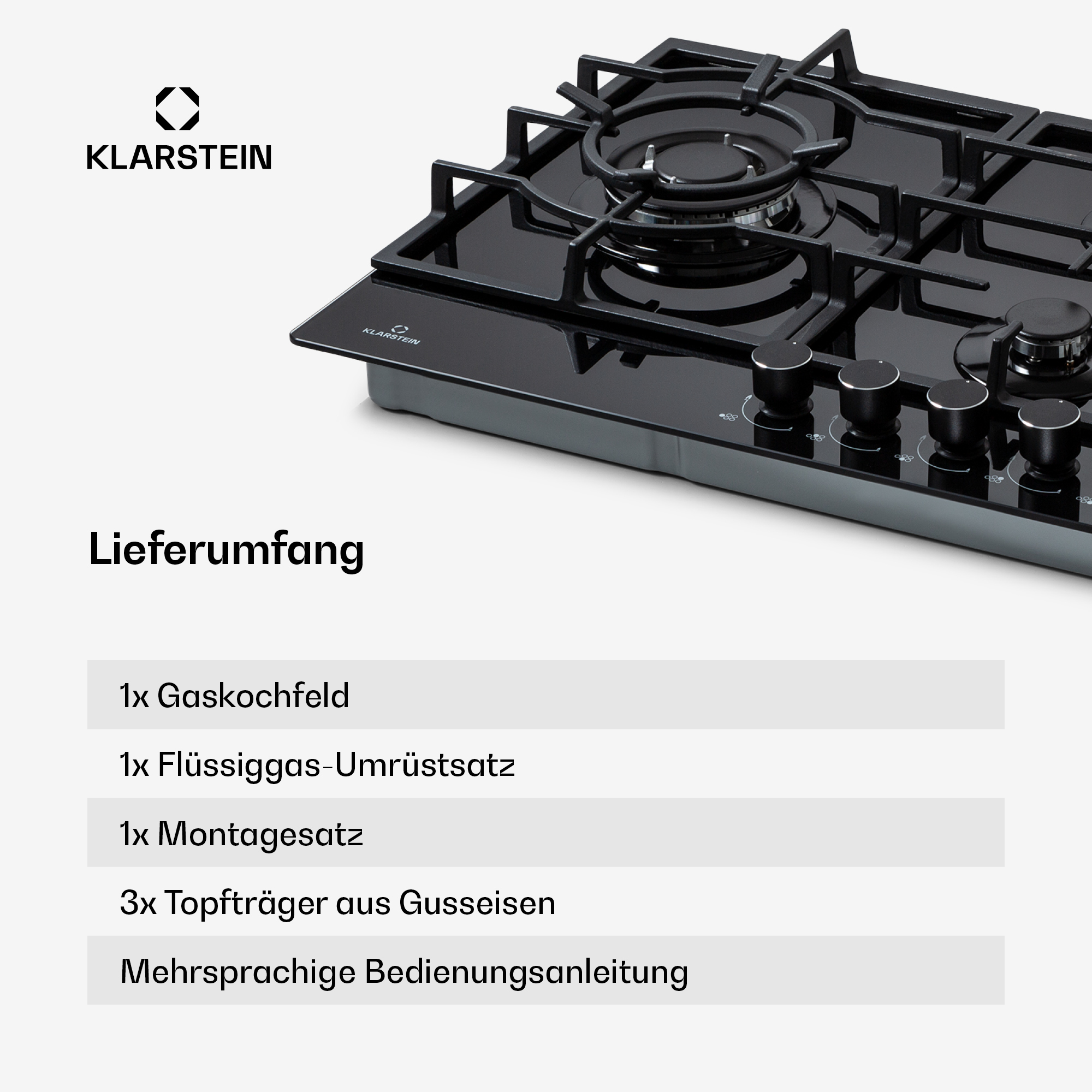 Ein schwarzes Gaskochfeld mit vier Brennern und silbernen Knöpfen.