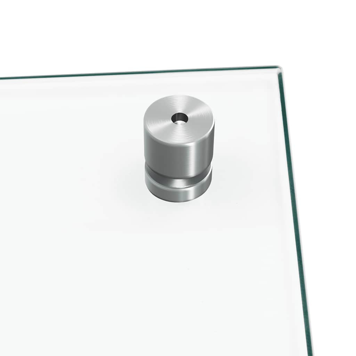 Ein runder, silberner Metallpfosten mit einem Loch sitzt auf einer Glasplatte.