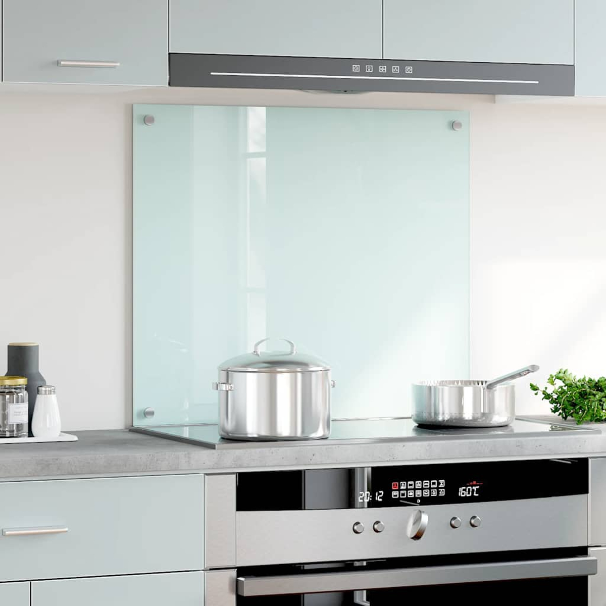 Una cocina con protector de pared azul claro, ollas y estufa.