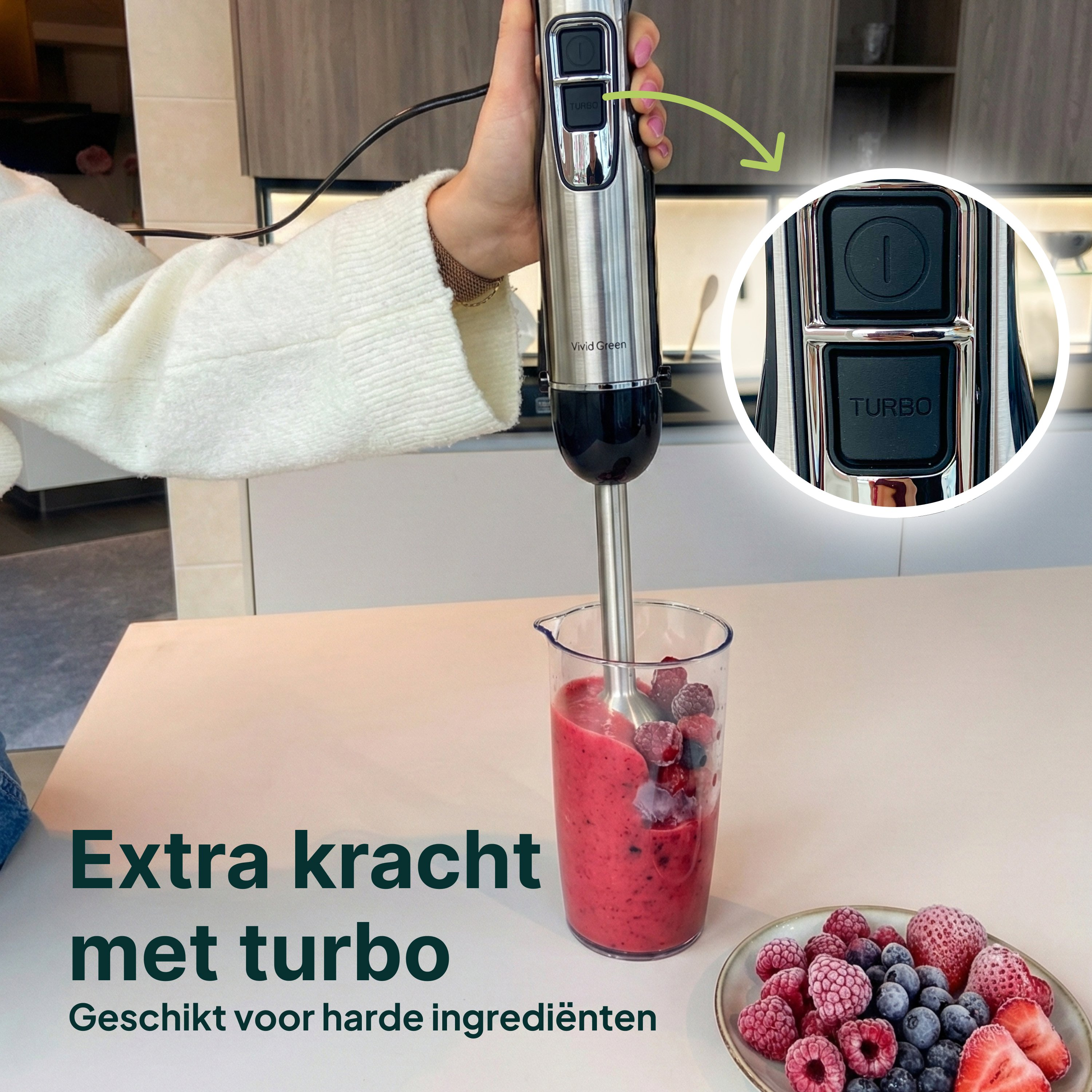 An immersion blender mixes berries in a glass. The TURBO button on the blender is highlighted.