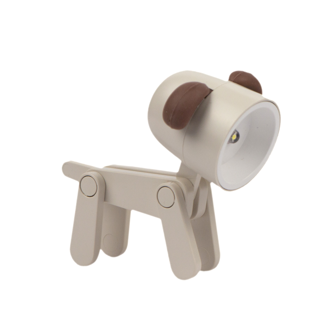 Una lampada da comodino beige a forma di cane con orecchie marroni e una piccola luce LED.