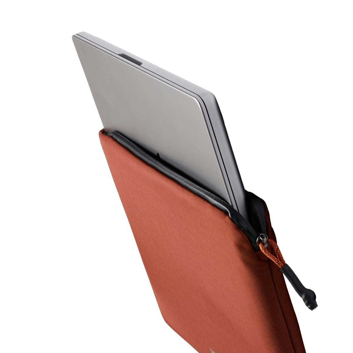 Un laptop argentato viene parzialmente inserito in una custodia arancione. Cerniera visibile.