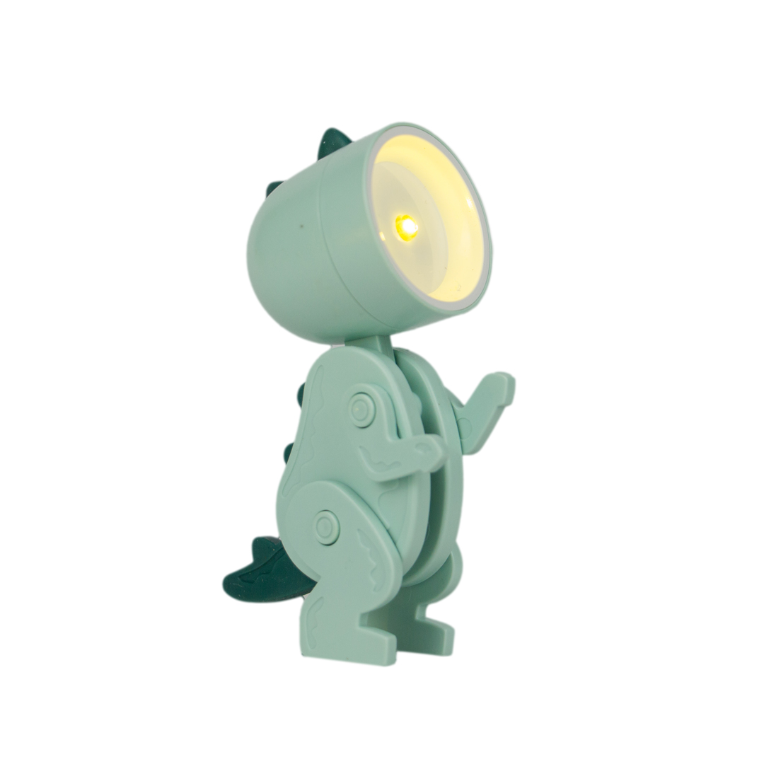 Una lampada dino verde con testa illuminata su sfondo bianco.