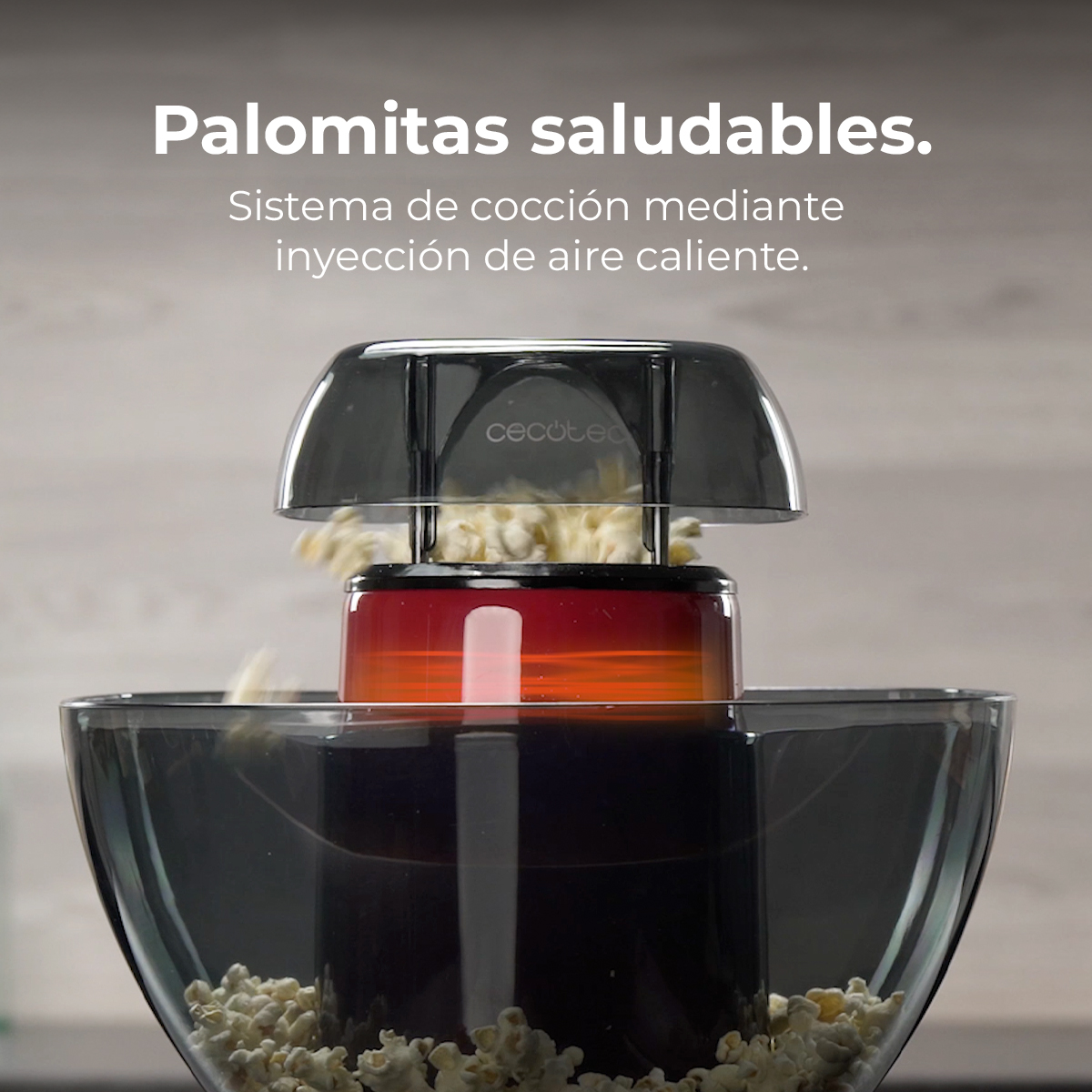 Una macchina per popcorn con corpo rosso e arancione sta facendo popcorn.