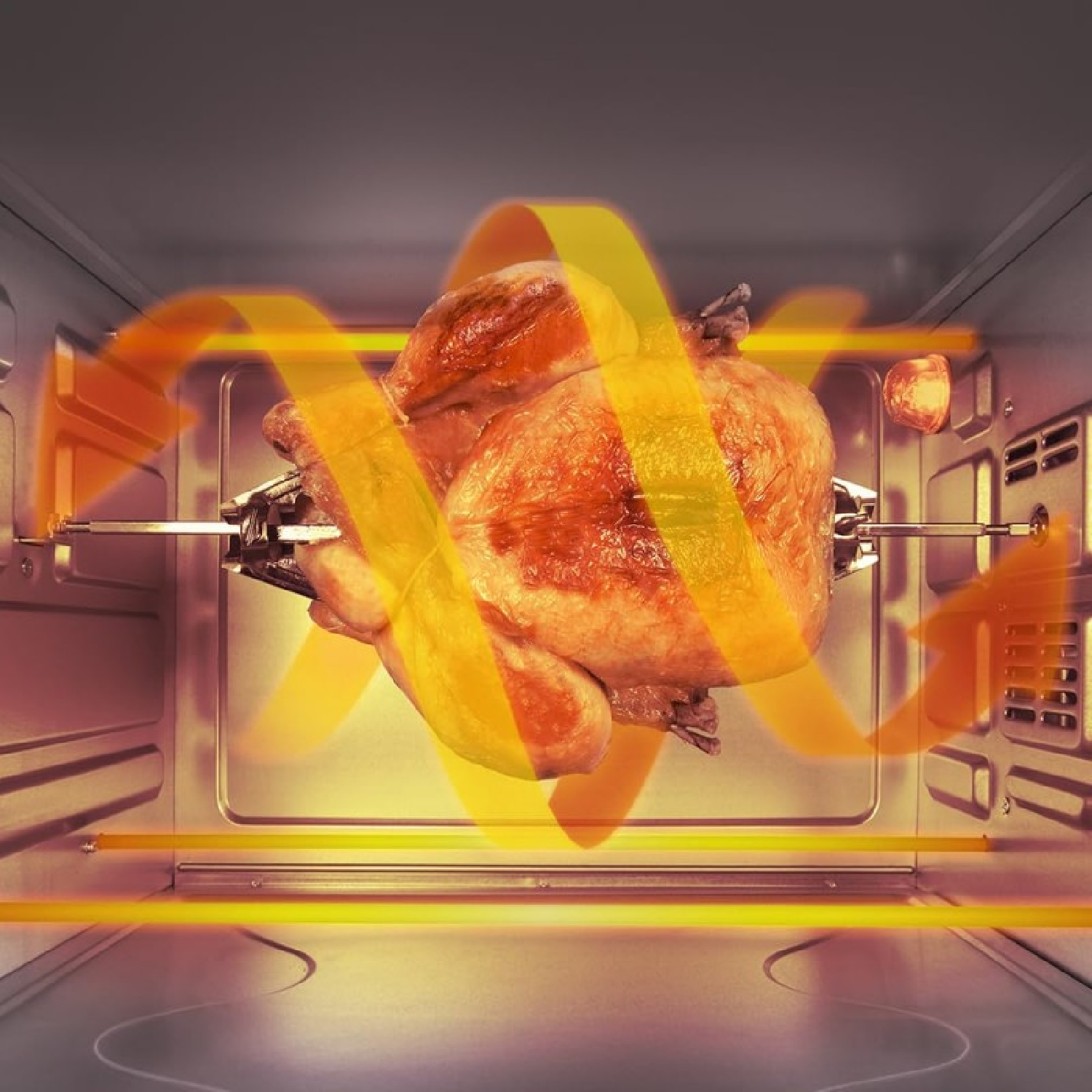 Pieczony kurczak obraca się w piekarniku z pomarańczowymi elementami grzewczymi i przepływem powietrza.