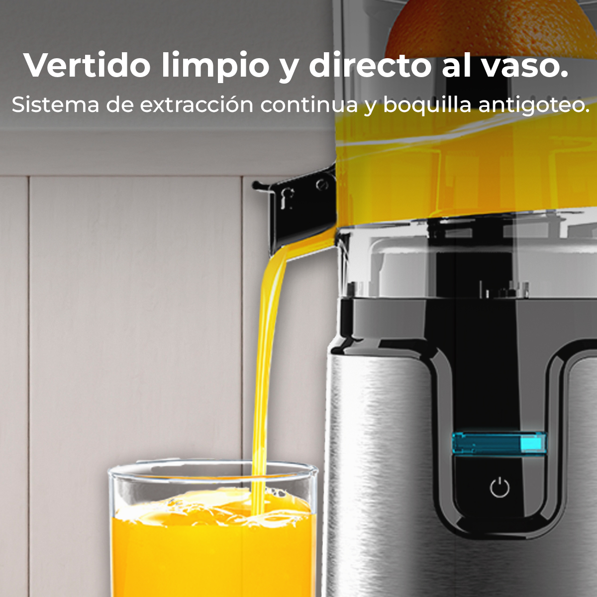 Il succo scorre da un estrattore in un bicchiere. Un estrattore con arancia.