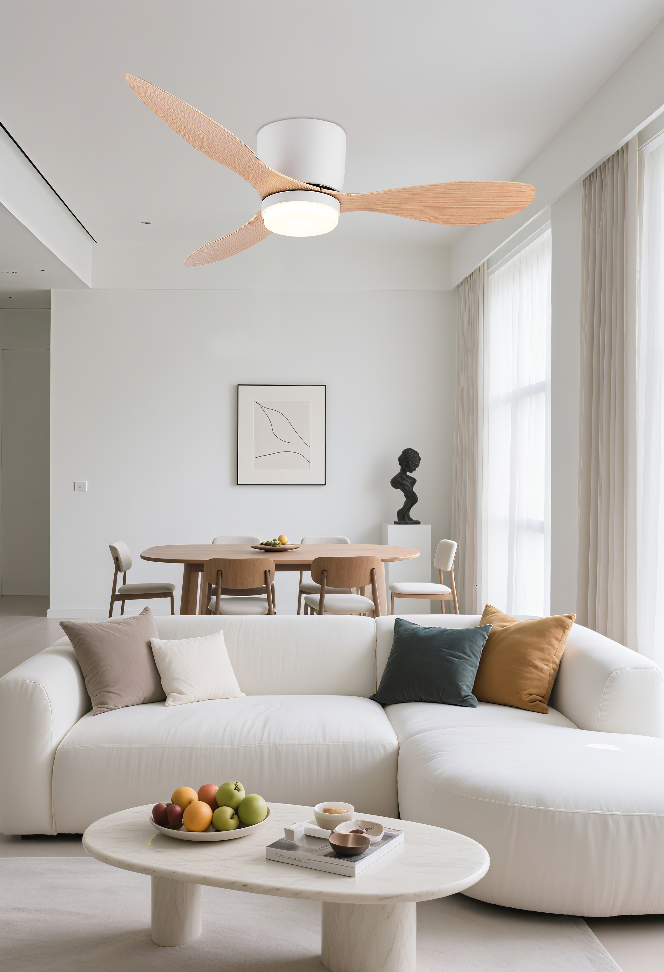 Una sala de estar luminosa con sofá blanco, mesa de madera y ventilador de techo.