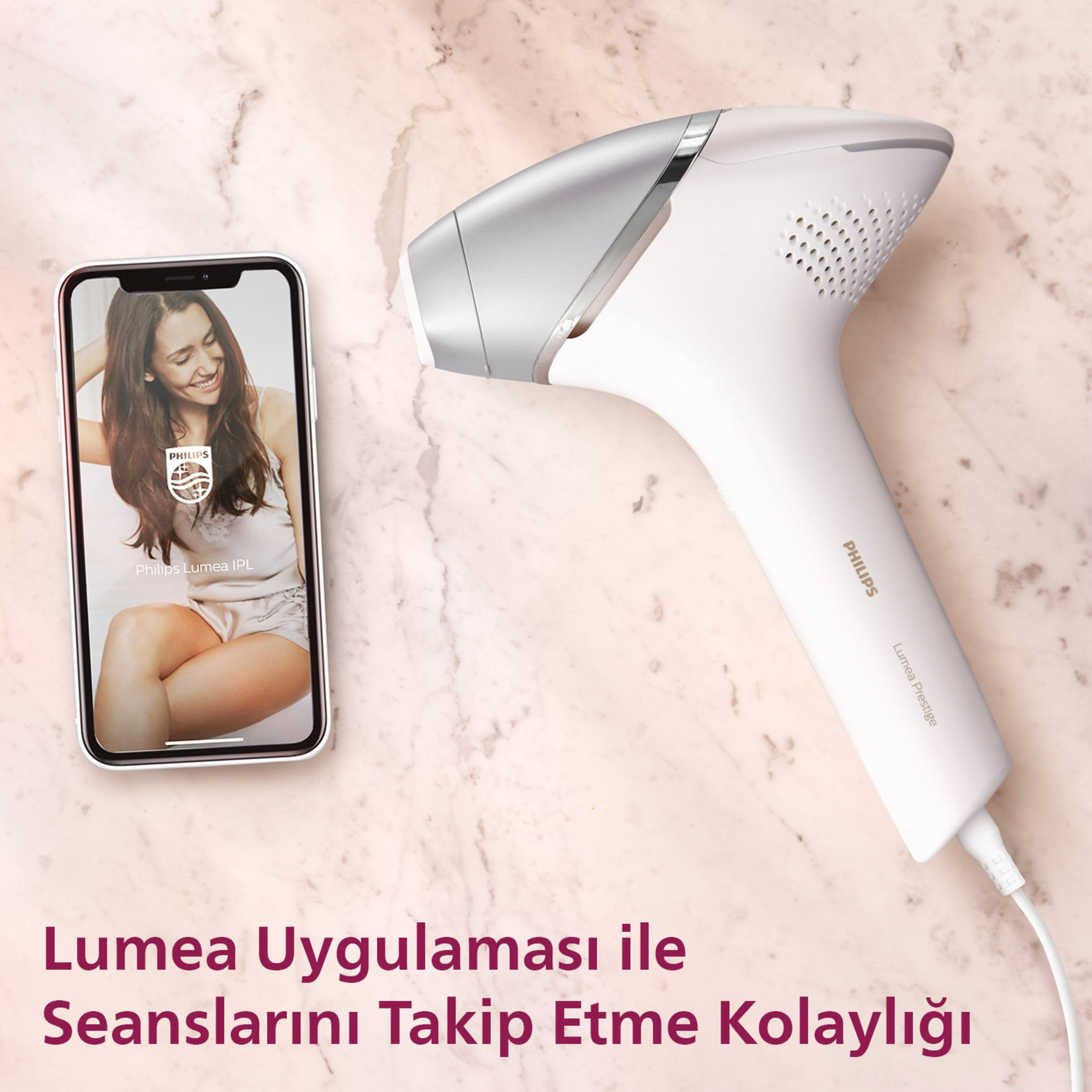 Lumea uygulamasını gösteren bir akıllı telefonun yanında Philips Lumea IPL cihazı.