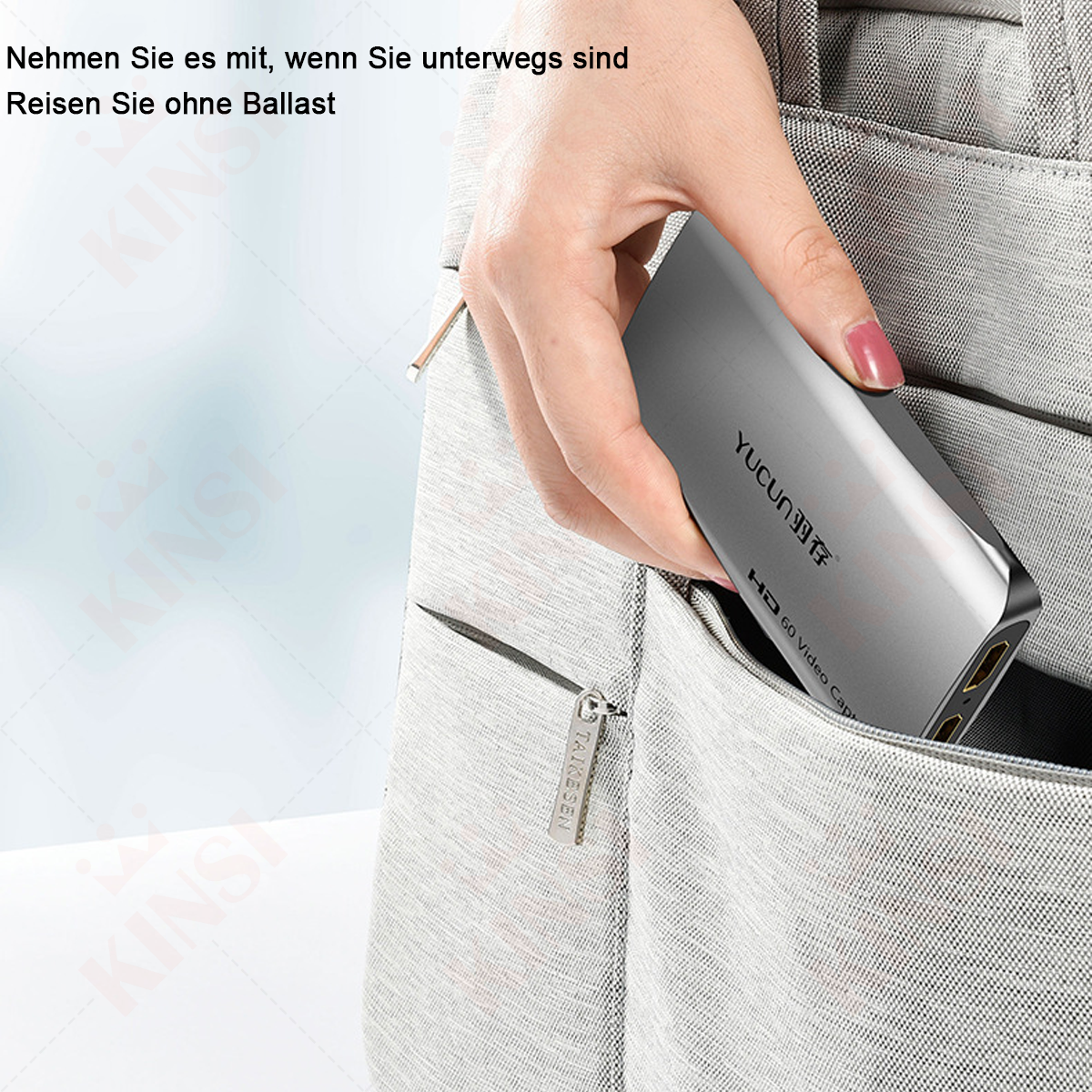 Eine Hand legt ein silbernes YUCUN HD 60 Video Cap in eine Tasche.