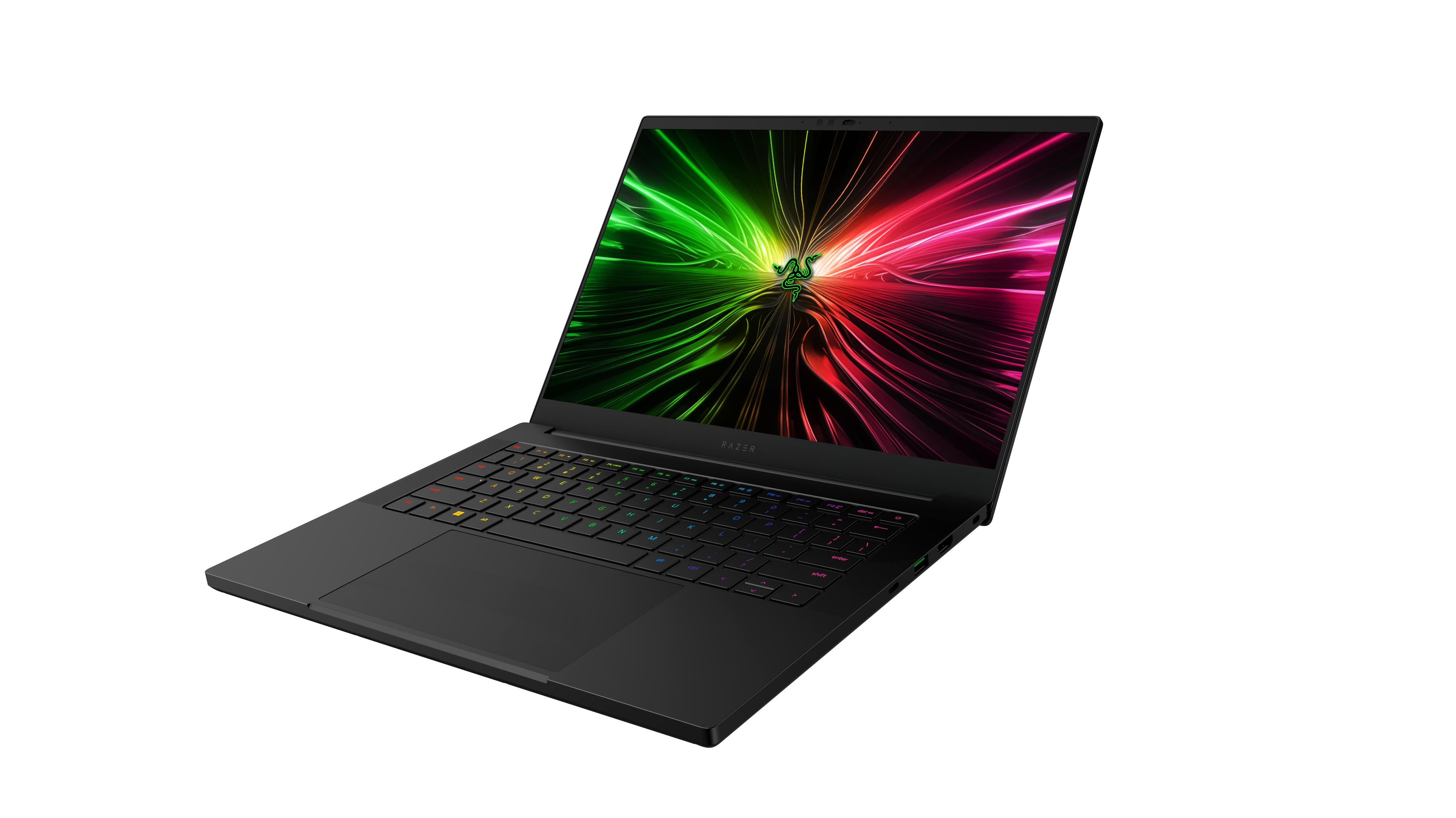 Czarny laptop Razer z żywعادةową zielono-różową tapetą abstrakcyjną na ekranie.