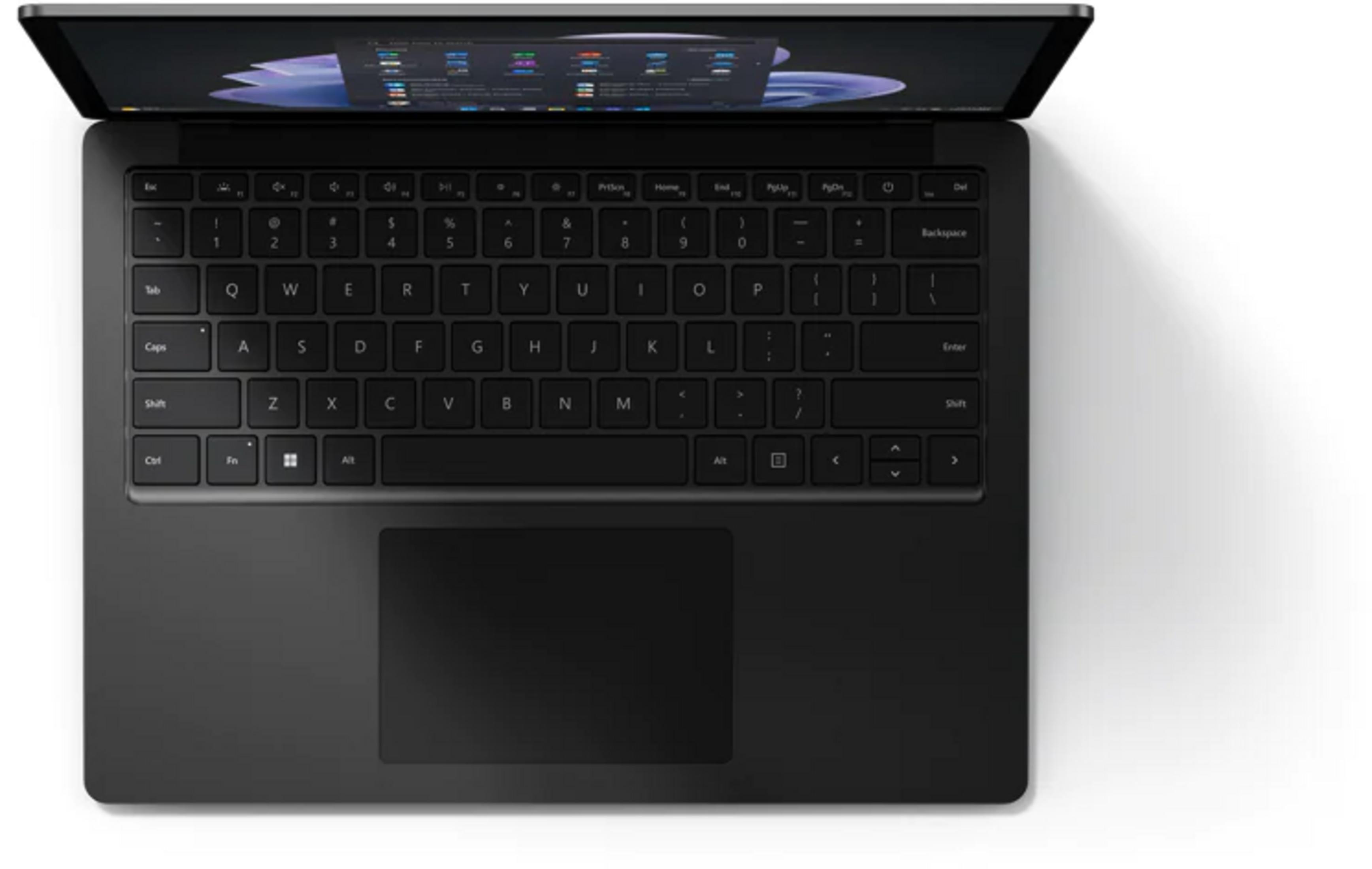 Ein dunkler Laptop mit geöffnetem Bildschirm, der die Tastatur und das Touchpad zeigt.