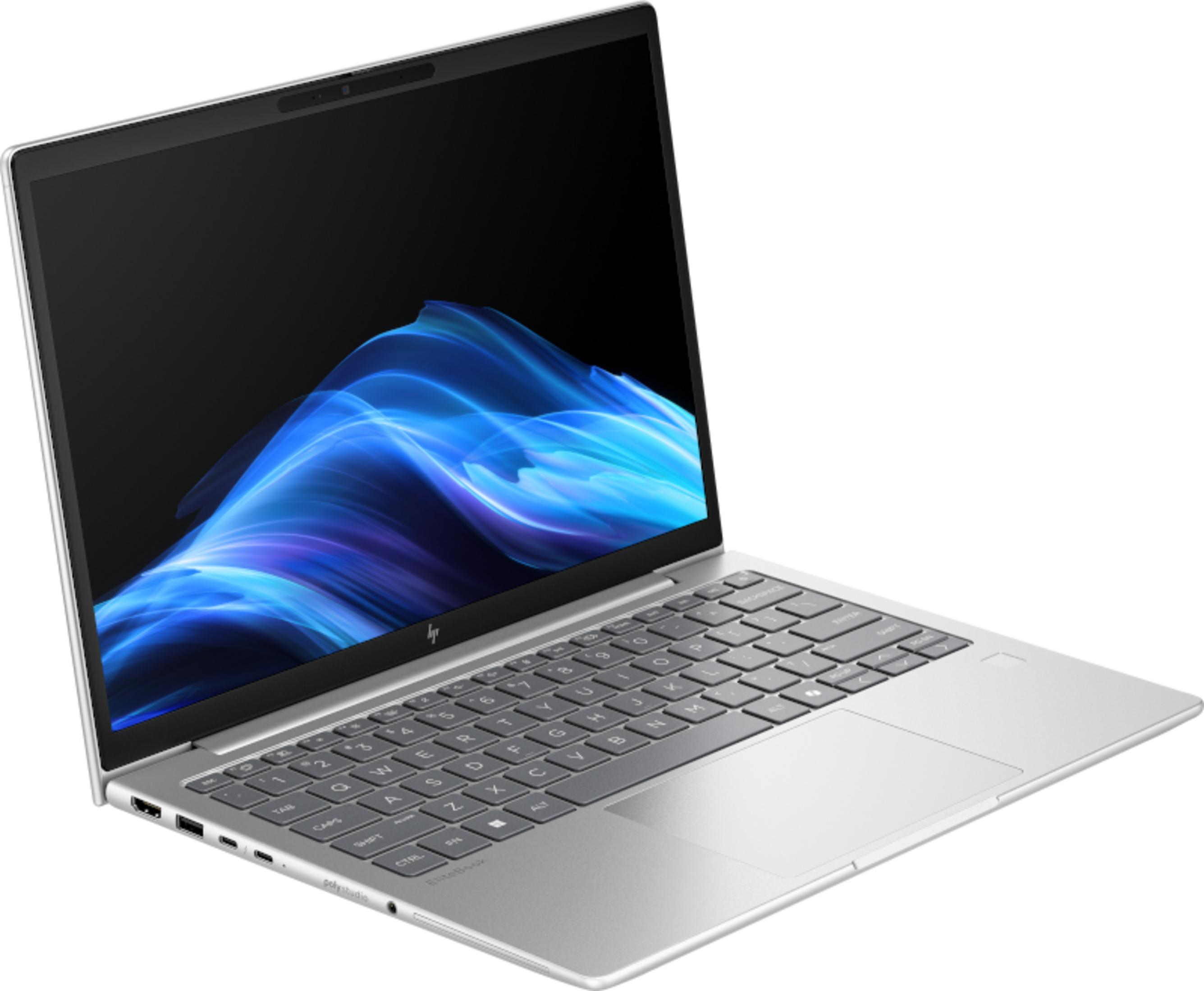 Un laptop argentato con un motivo ondulato blu sullo schermo.