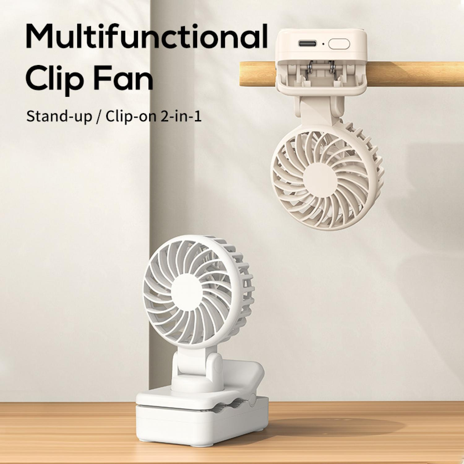 Ein weißer Clip-Ventilator steht auf einem Holztisch, ein zweiter hängt an einer Stange.